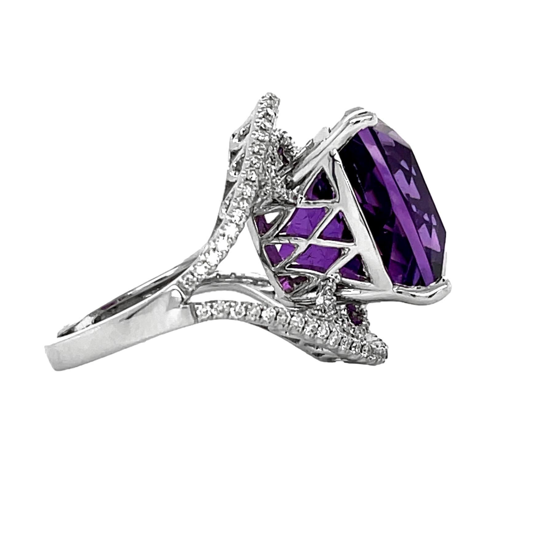 This stunning Statement ring has a cushion 15x15mm AAA quality African Amethyst with 4 prong setting in 14 karat white gold. There are 108 shimmering brilliant cut round diamonds on the shank. This beautiful ring will be the talk of your special