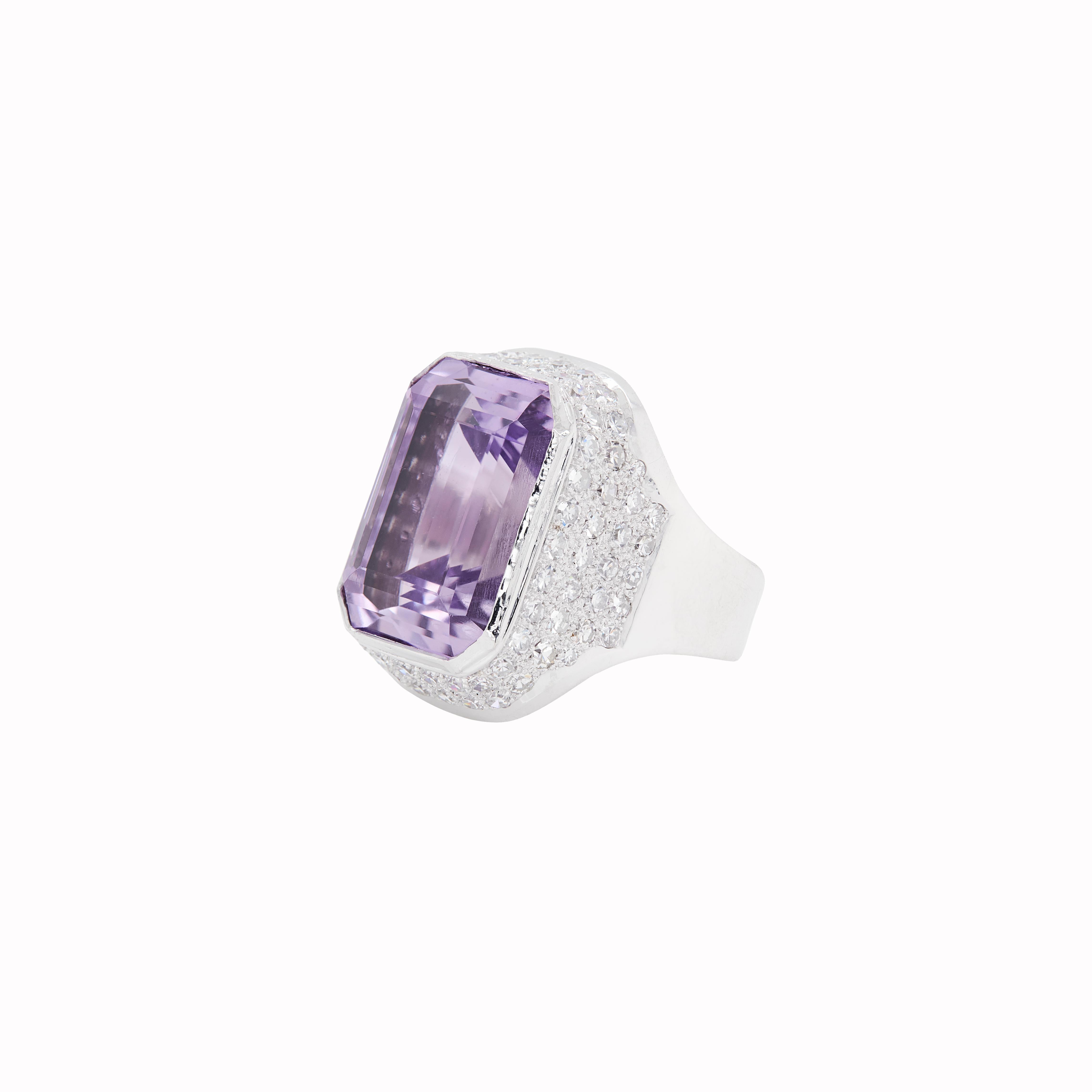 Make a statement with this fantastic amethyst and diamond cocktail ring, exquisitely crafted in luxurious 18 carat white gold. 

At the heart of this piece sits an impressive, emerald cut transparent amethyst with a lilac hue, measuring