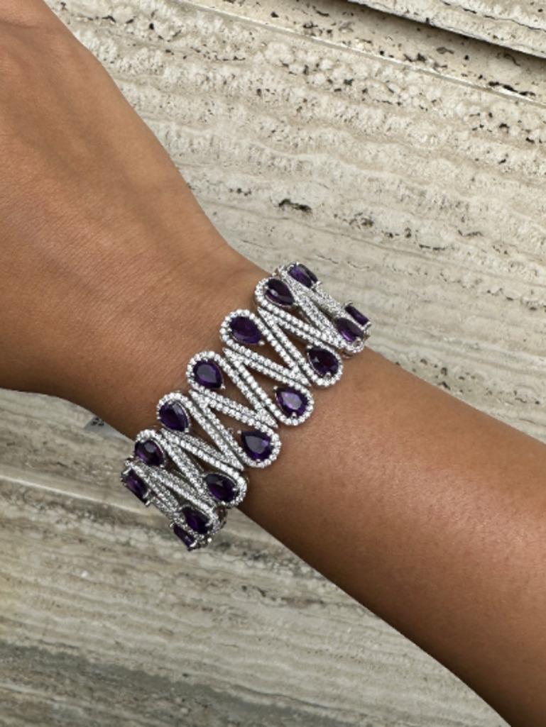 Amethyst and Diamond Bold Wedding Bracelet in sterling silver showcases endlessly sparkling natural amethyst, weighing 43.7 carat. It measures 7 inches long in length. 
Amethyst stimulate concentration and reduces stress. 
Designed with perfect