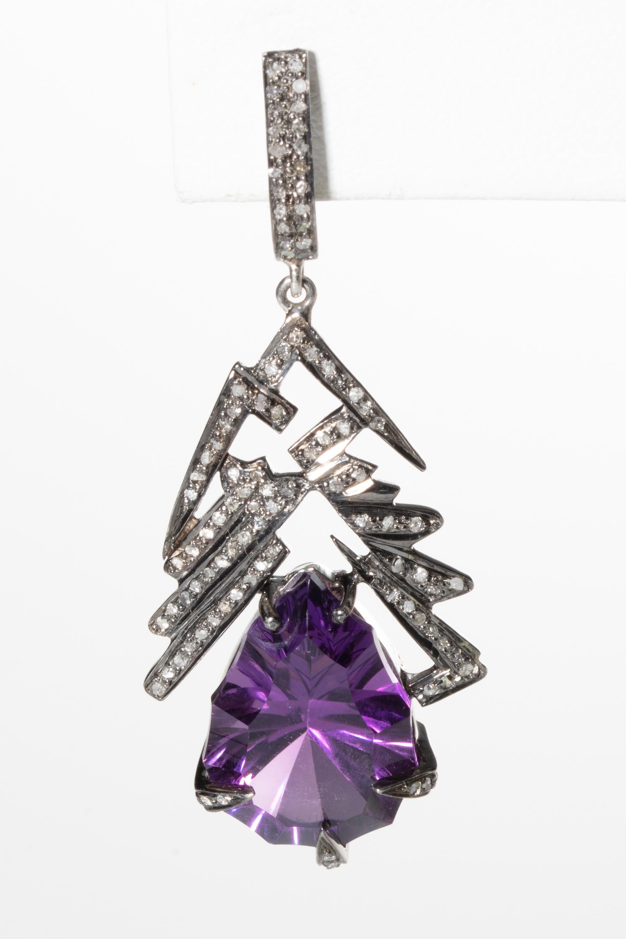 Unusually cut pear-shaped large amethyst drops suspended from a stylized Art Deco configuration of pave-set diamonds set in an oxidized sterling silver.  Sterling silver and diamond loop post for pierced ears.  Weight of diamonds is .75 carats,
