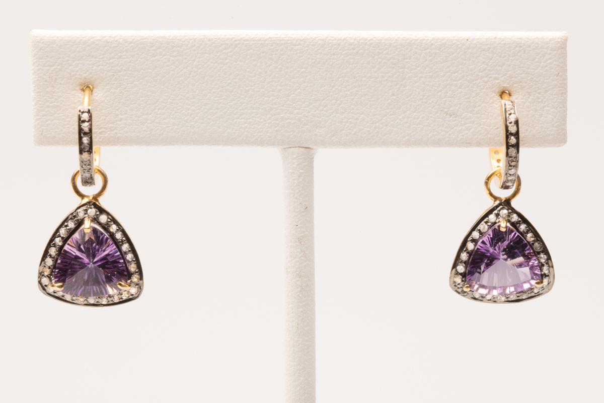 Trillion cut amethyst bordered in diamonds set in sterling silver and gold with 18K gold post.  The diamond top portion is a hoop with a snap-in closure and diamonds all around.  The amethyst pendant hangs from the hoop and could be taken off. Carat