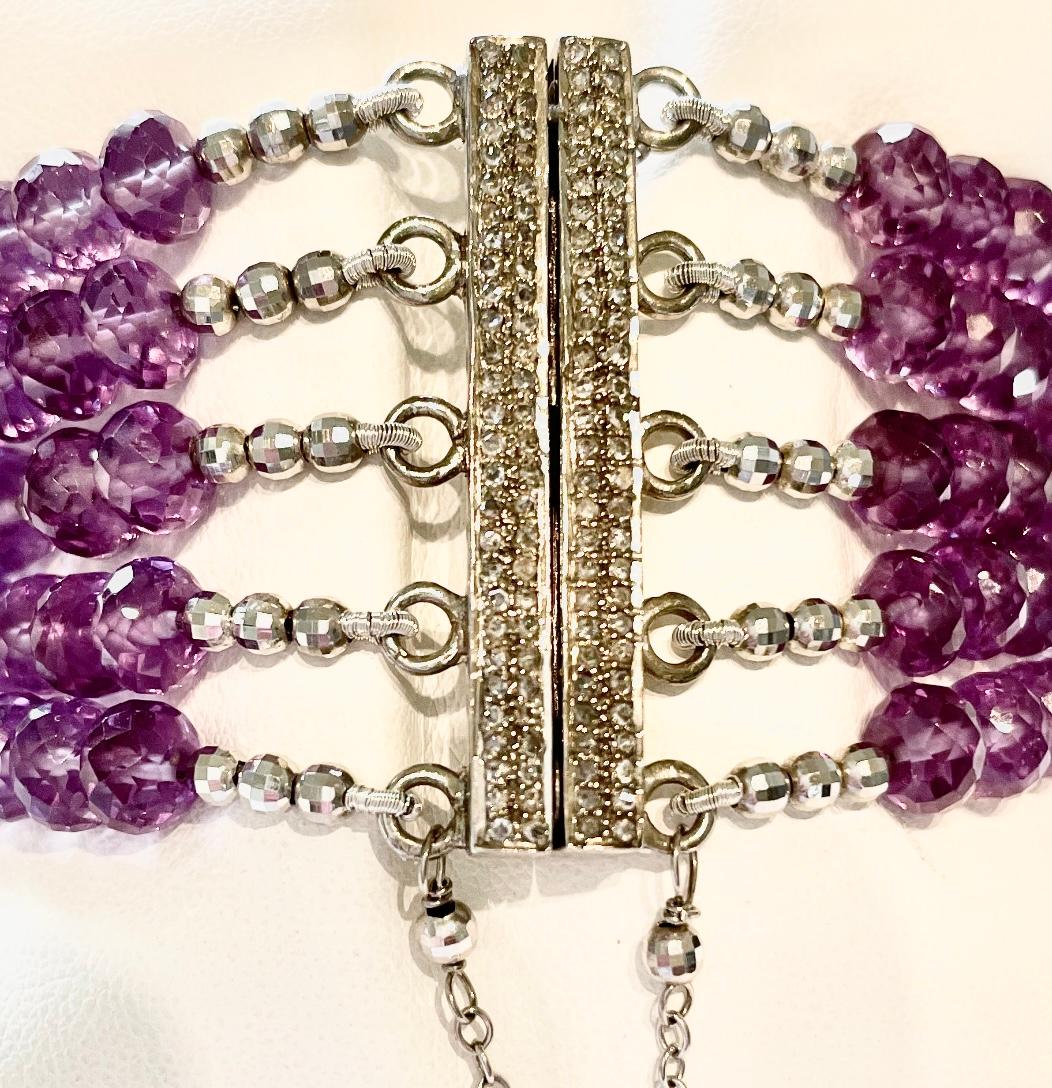 Description
Amethyst 300 carats, pave diamond centerpiece. Unique, strong magnetic pave diamond clasp for ease of use, secured with a safety chain, 5 strand bracelet.          
Item # B1218
Check out matching ring and earrings, see last photo. Ring