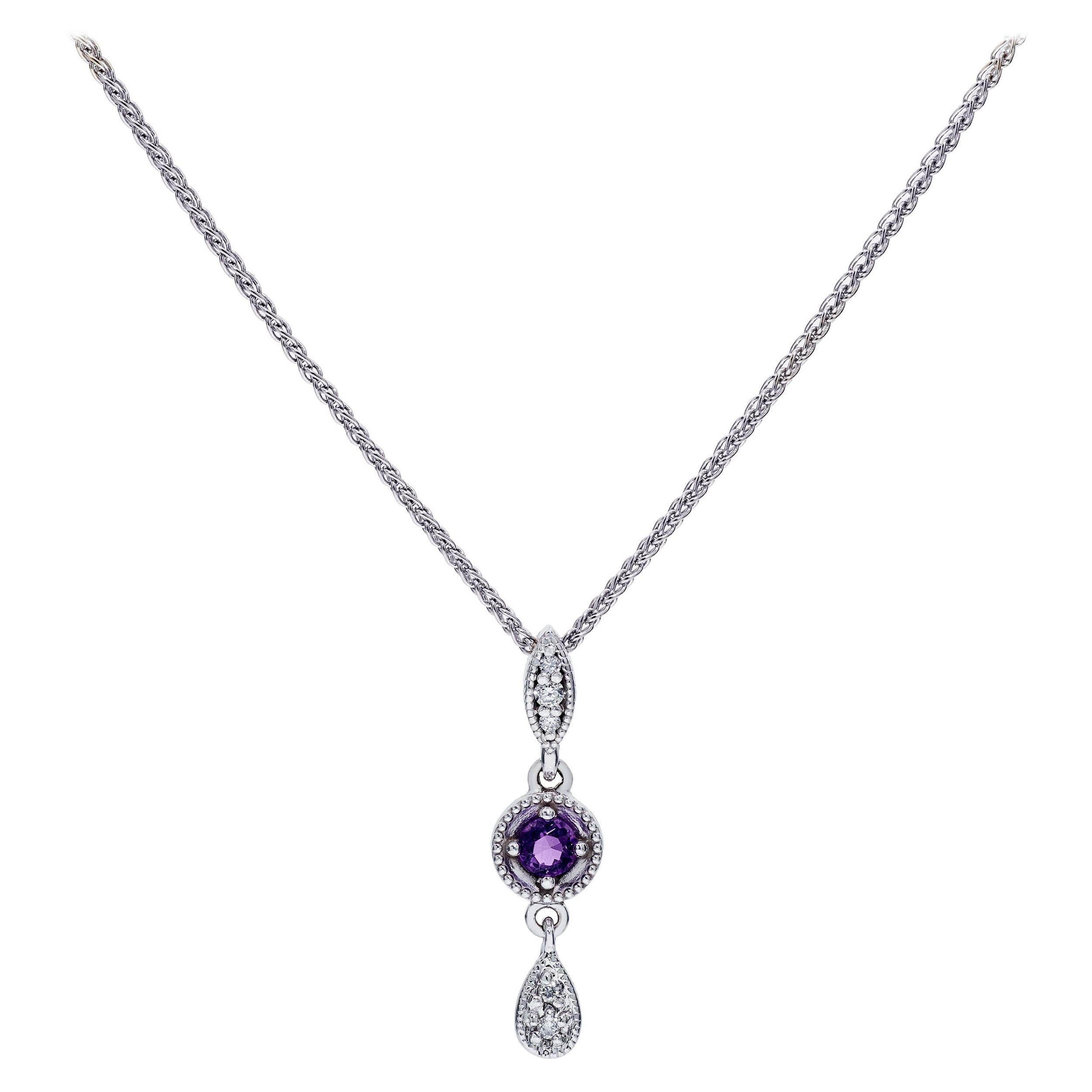 A precious matching set with 0.34 Carats Total Weight of Amethyst and Diamonds.  The pendant hangs on an 18