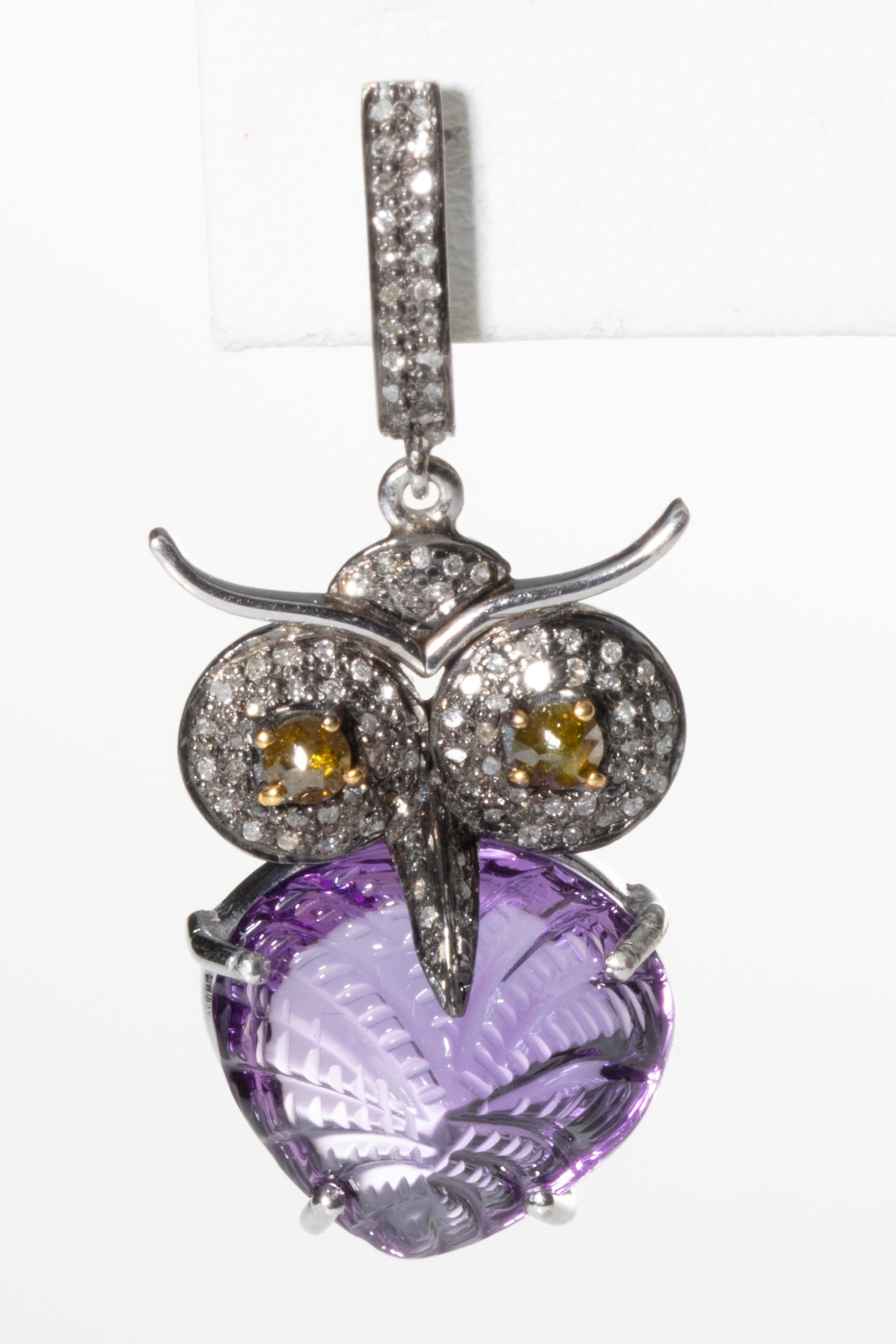 Whoo, whoo!  How cool are these.  Carved and textured amethysts comprise the body of these owl earrings.  Faceted champagne diamond eyes and pave-set diamonds make up the rest of the face, beak and post.  Set in sterling silver, with a French clip
