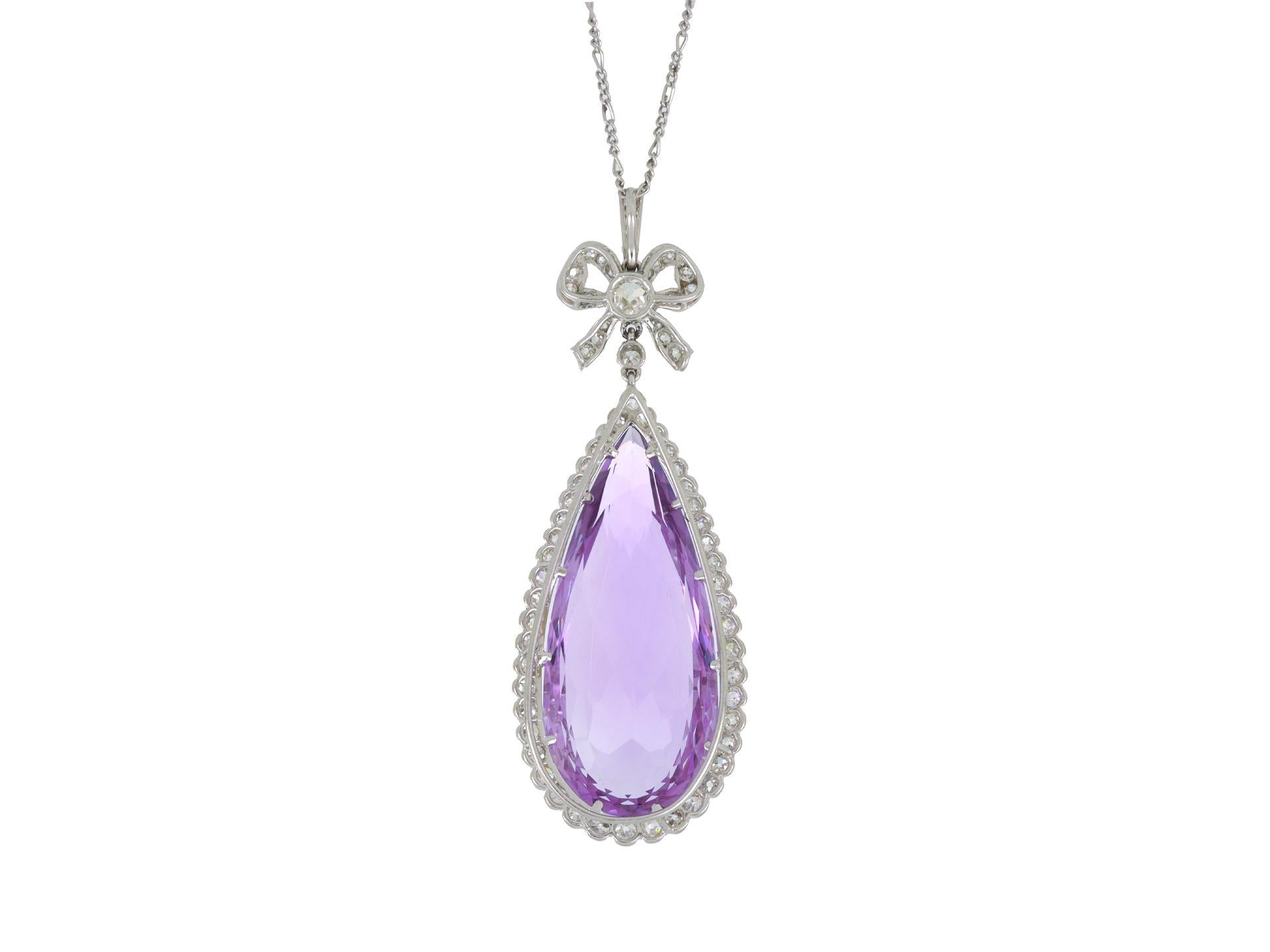 Amethyst and diamond pendant. Set to centre with a drop shape old cut natural amethyst in an open back claw setting with an approximate weight of 25.00 carats, encircled by forty-five round eight cut diamonds in open back rubover settings with an