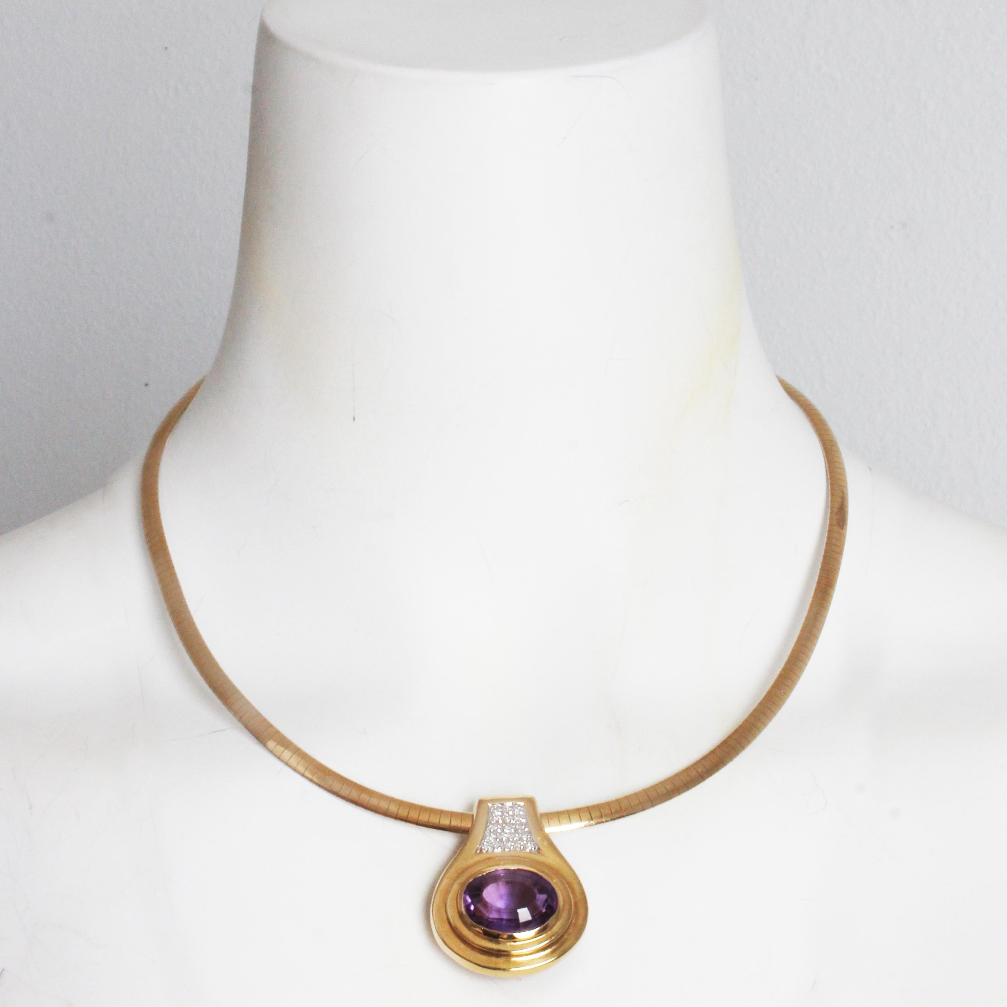 Fabulous amethyst and diamond slide pendant with yellow gold and rhodium Omega chain, likely made in the latter half of the 20th century.

The 14k yellow gold slide pendant is accented with one (1) large bezel set oval cut natural amethyst stone and