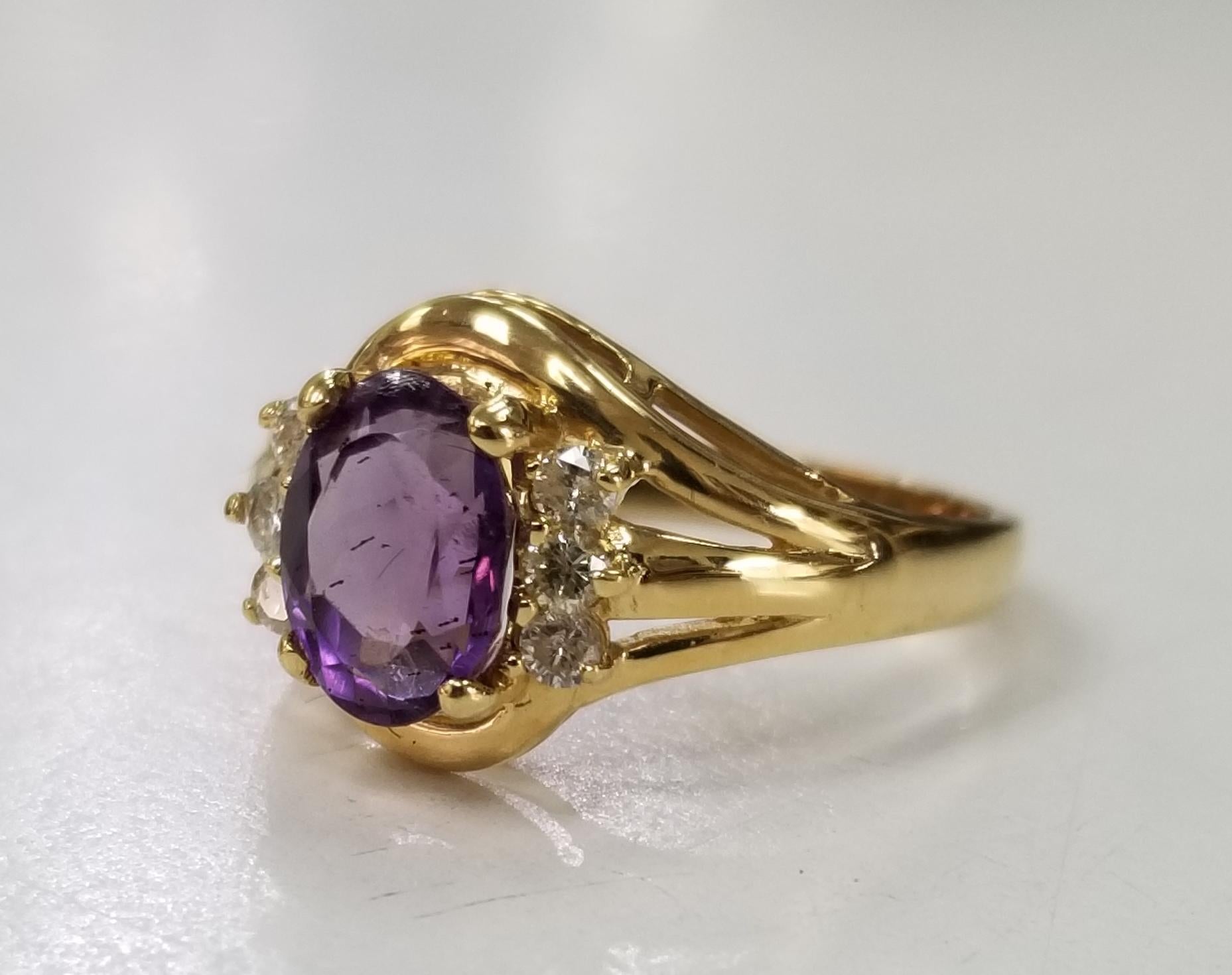 14k yellow gold amethyst and diamond ring, containing 1 oval cut amethyst of gem quality weighing .1.35cts. and 6 round full cut diamonds of very fine quality weighing .18pts.  This ring is a size 5.75 but we will size to fit for free.