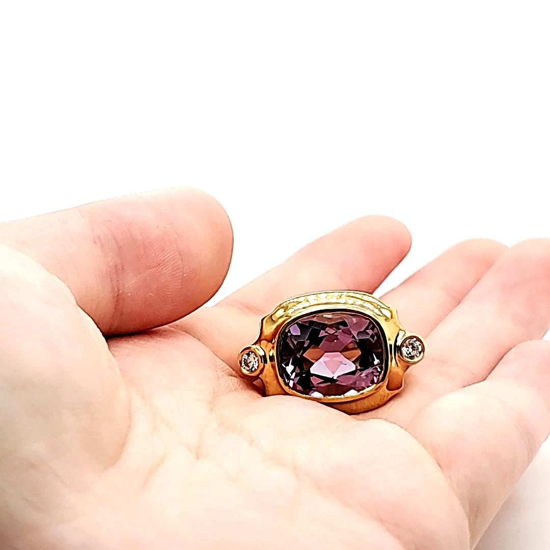 Amethyst and Diamond Ring in 18 K gold.

A bold and brilliant statement ring that has a faceted amtheyst of Brazilian origin of cts 7.69 as the centrestone.

It is a clean, bright and lustrous stone of medium tone that throws light in every