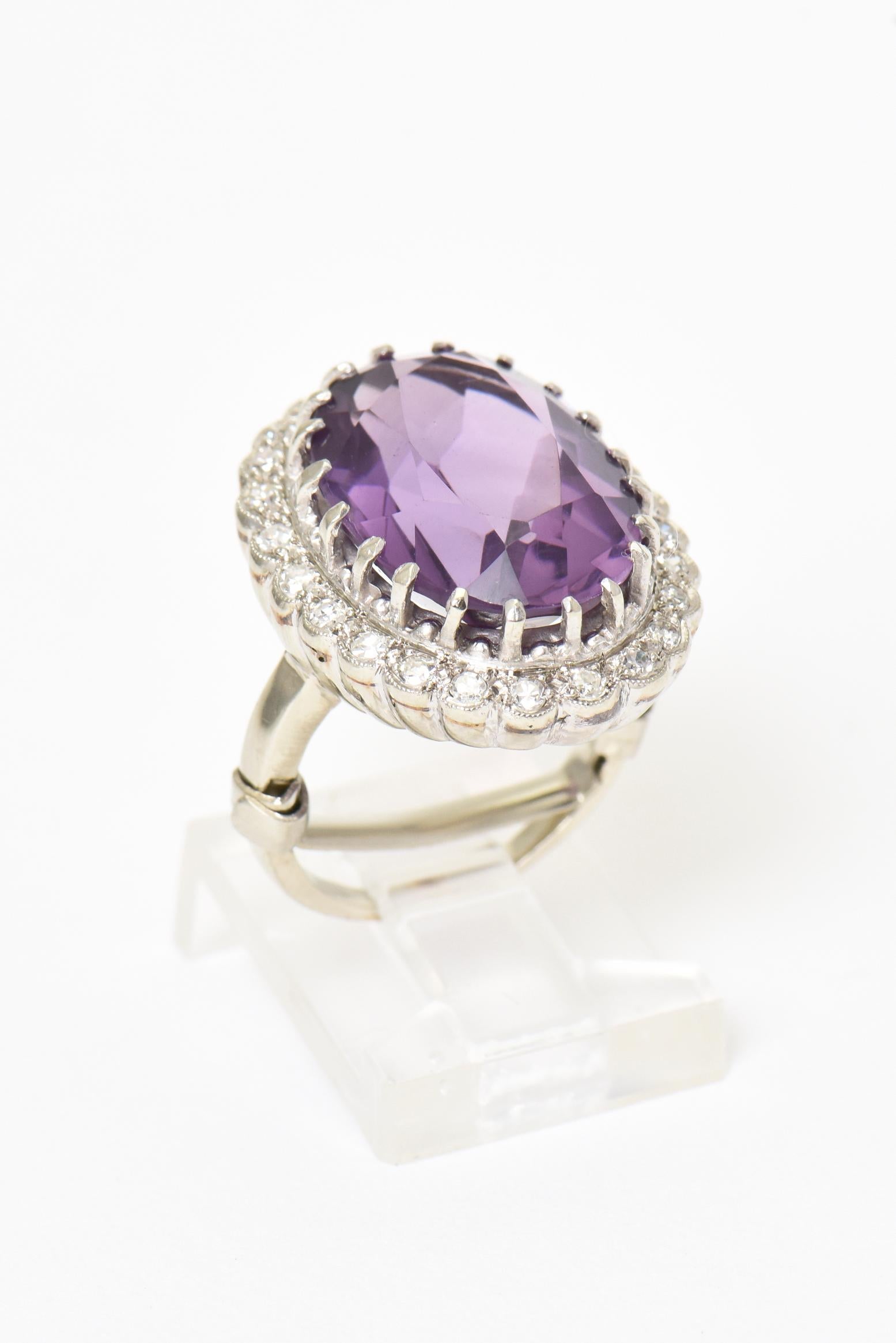 Beautiful color purple oval faceted amethyst prong mounted in a diamond 14k white gold frame. The frame has 23 single cut diamonds weighting approximately .34 carat in total weight for the piece. Marked 14k.  IT measures .94