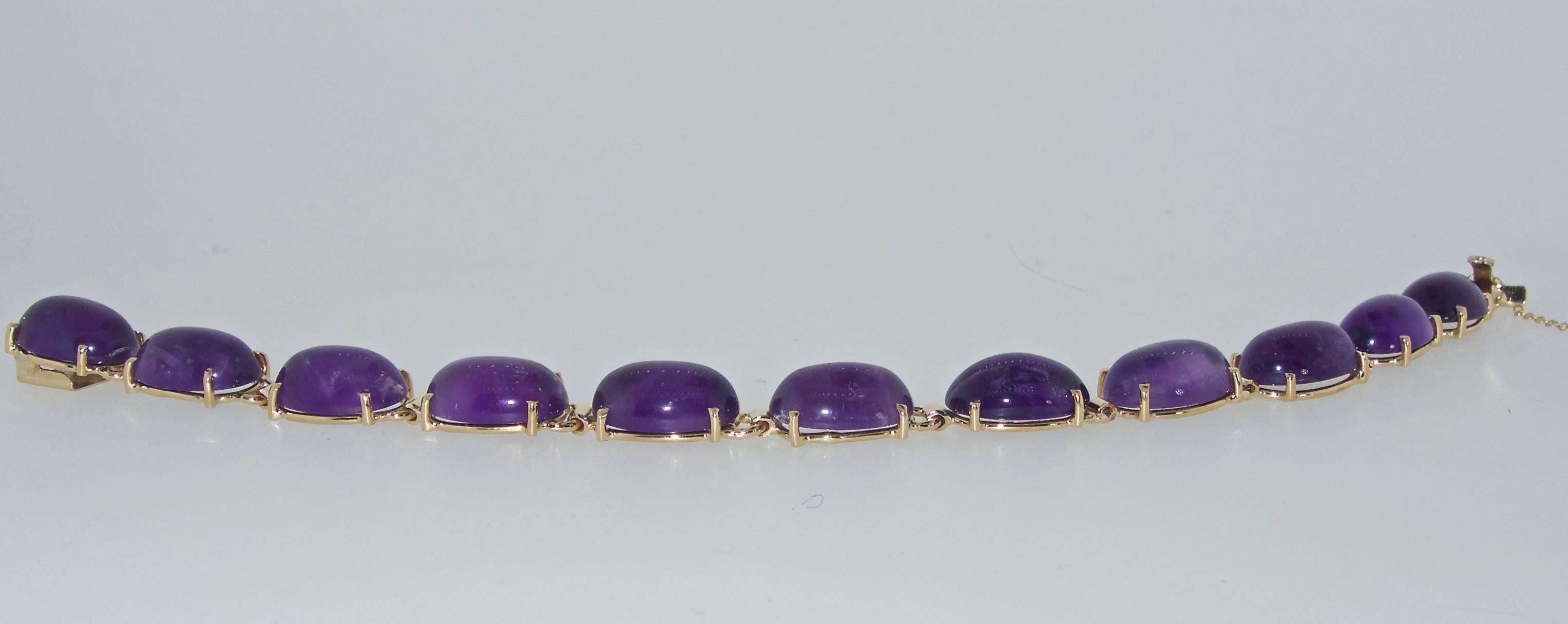 11 fine purple amethysts, cabochon cut, averaging 5.5 cts and totaling approximately 60 cts.  All stones are well matched, vibrant and well set.  Length is 7.25 inches and weighs 20.95 grams.