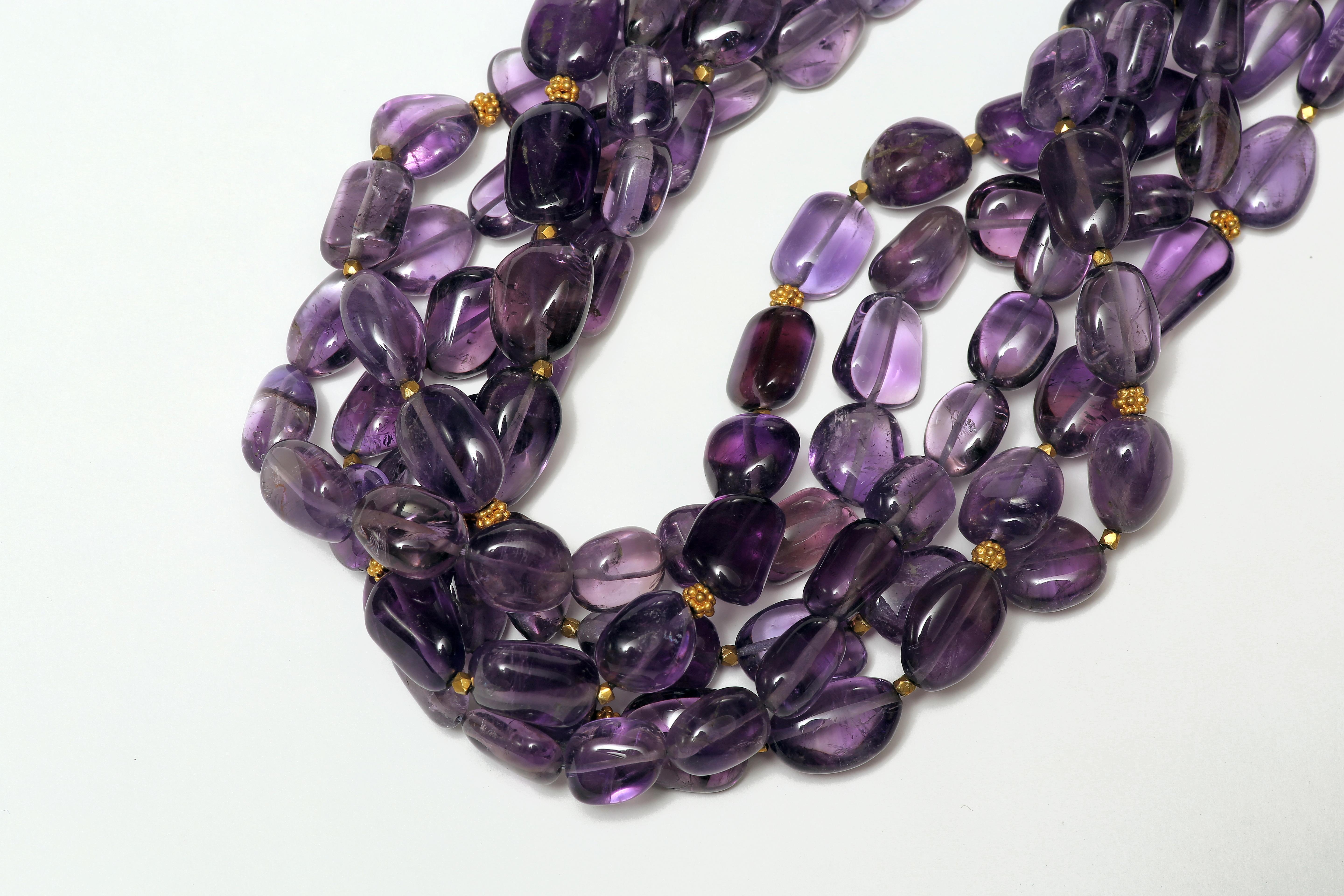 Five strings of amethyst, with scattered faceted gold beads spaced to catch the light, and an 18k gold toggle and ring clasp. They intertwine and twist to form this elegant necklace. Amethyst is believed to have the power of protection and to