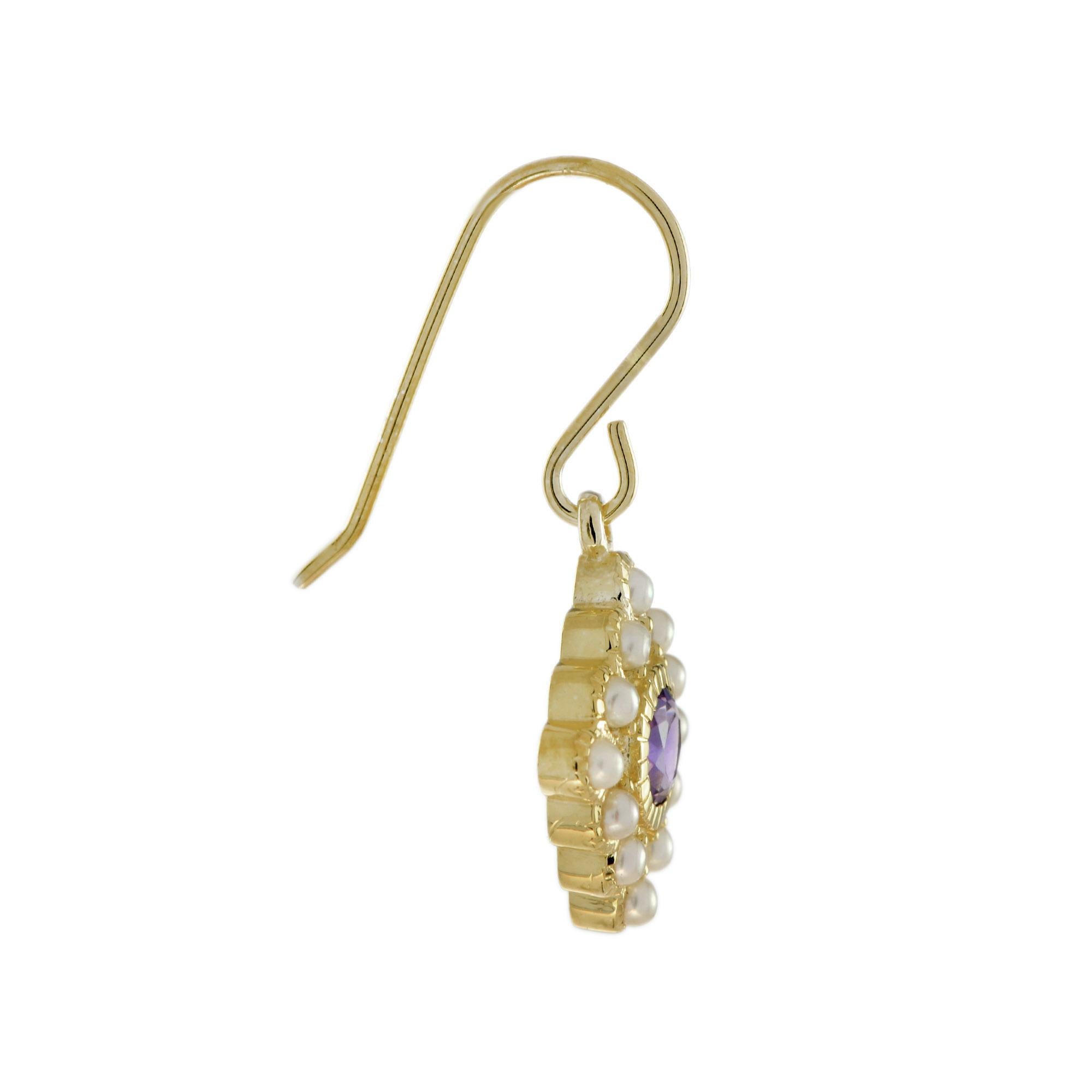 A lovely pair of vintage inspired drop earrings, set with a central round cut amethyst, surrounded by twelve pearls on each side. All set in 14k yellow gold with French wire backing. 

Earrings Information
Style: Vintage
Metal: 14K Yellow