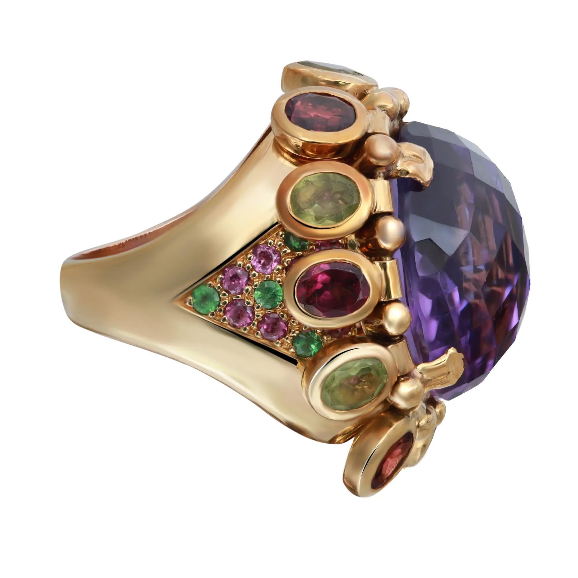 This stunning cocktail ring features a purple oval shape faceted amethyst accented with hanging bezel set amethyst and peridot stones all around the center stone encrusted with purple and green round glass stones on both sides of the band. This