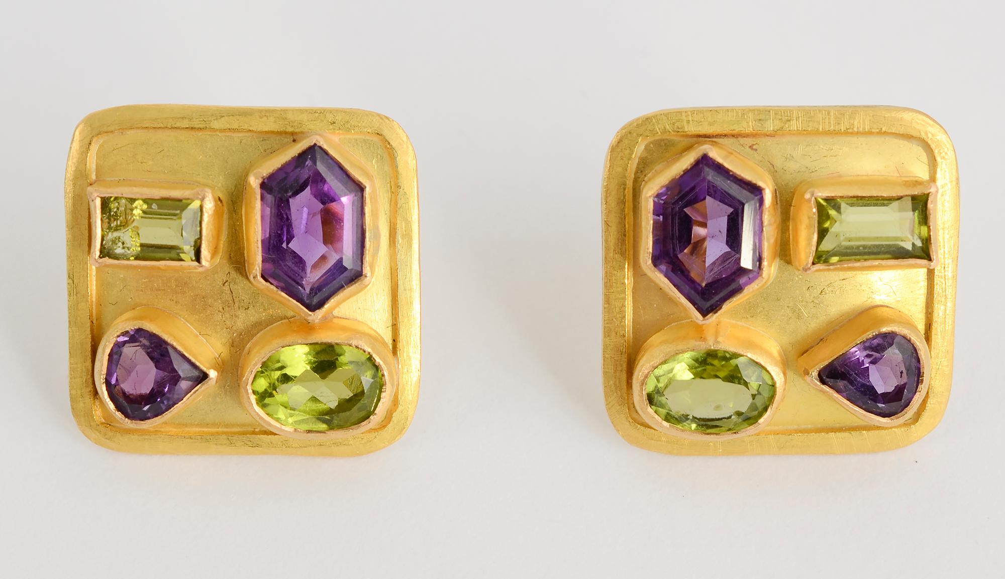 Artist made earrings and matching pendant. Irregular shaped amethysts and peridots make a wonderful design on a 22 karat matte ground. The earrings measure 3/4