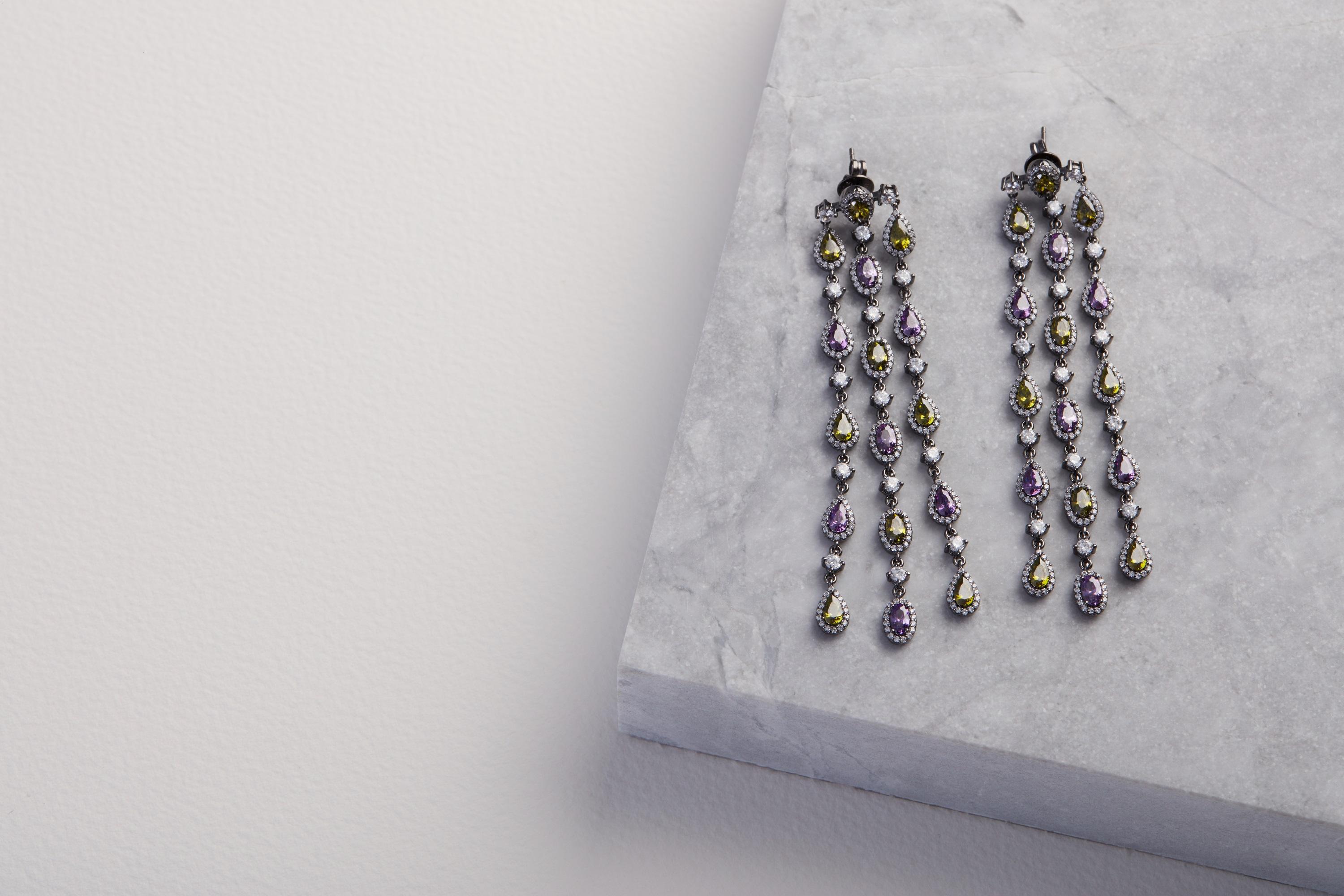 A dazzling dripping gems. Platinum and Black rhodium plated sterling silver with hand hand set with beautiful amethyst, peridot and clear zircon. A game changer for any outfit!  11 cm in length
