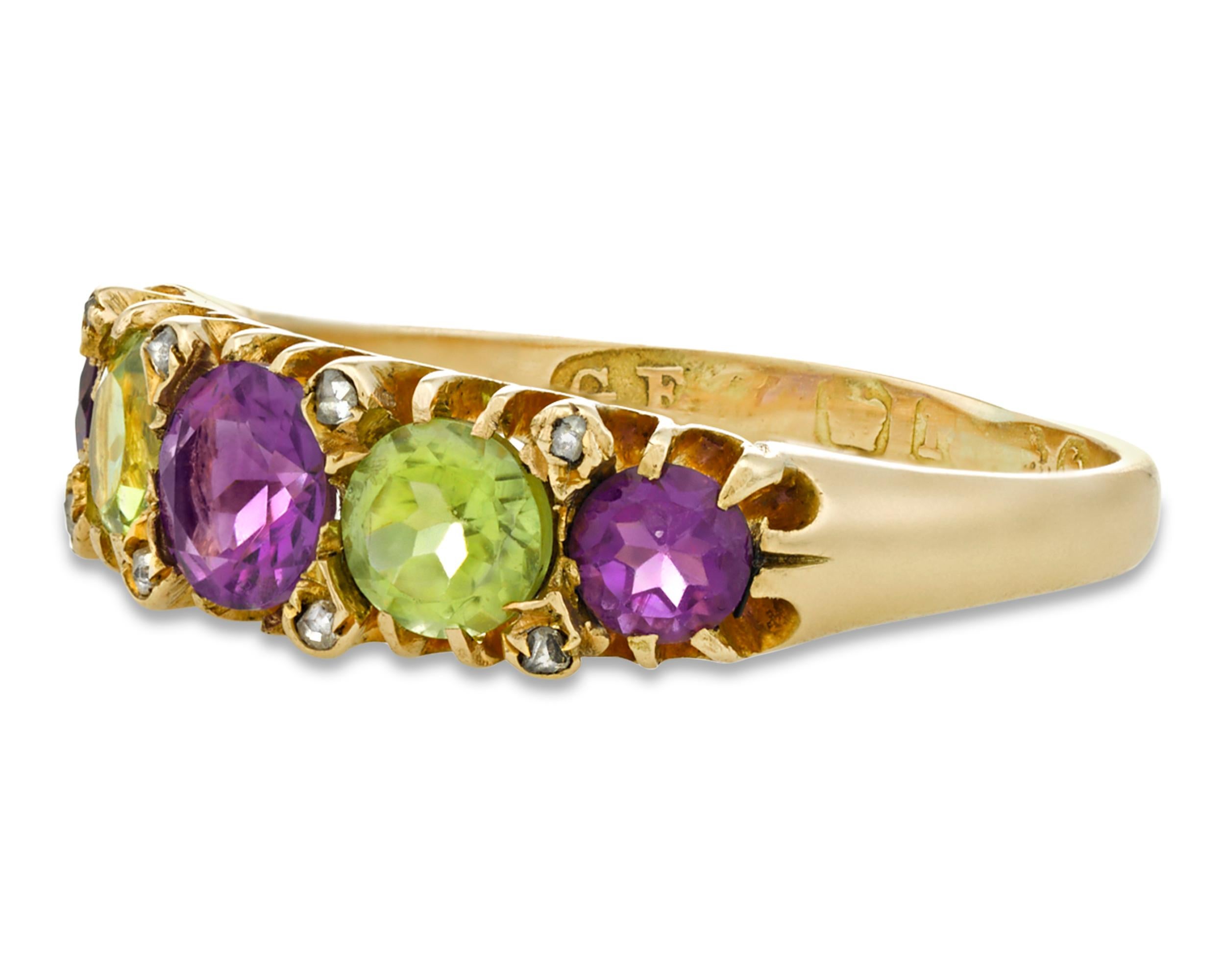 An exquisite antique ring with remarkable historical significance, this Edwardian work of jeweled art was worn by a British Suffragette to show her support for the movement. The official colors of the women's suffrage movement were green, white and