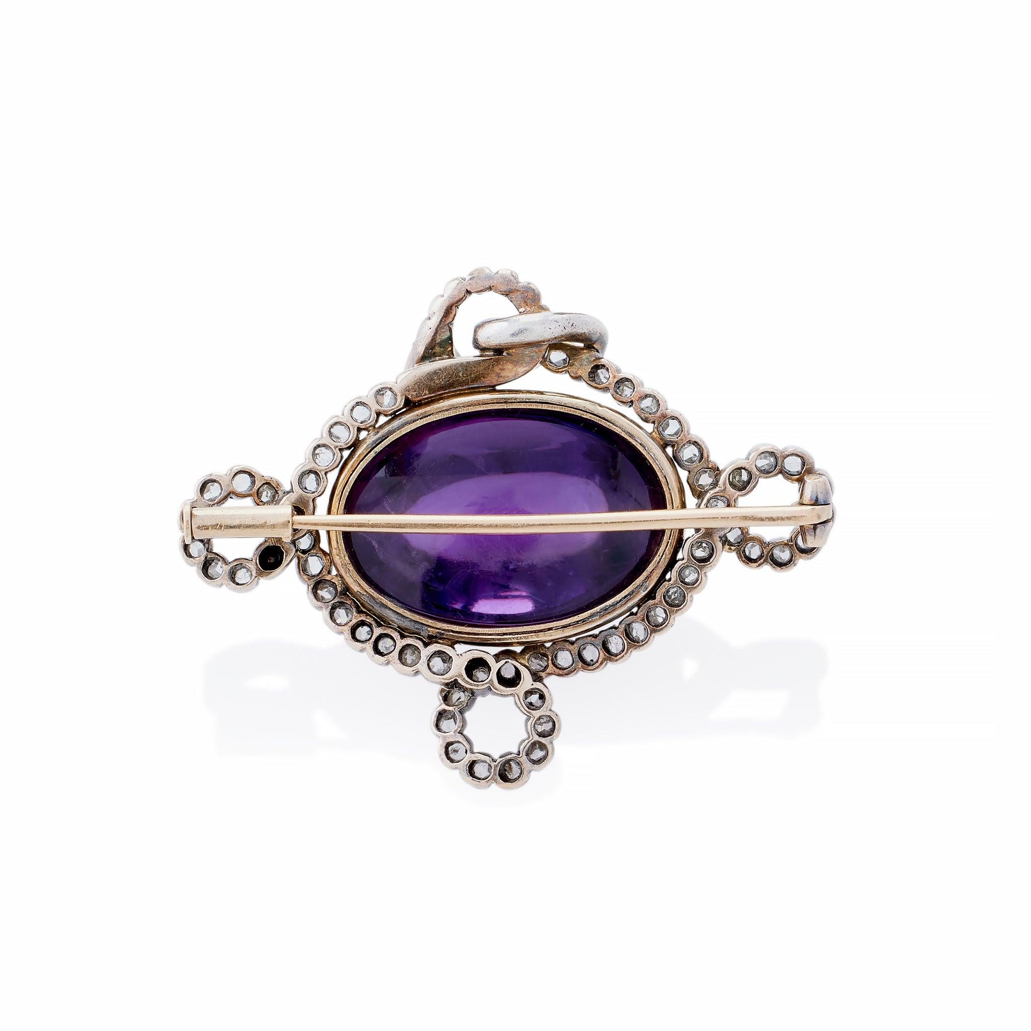 Dating from circa 1880, this serpent brooch is composed of an amethyst cabochon and rose-cut diamonds set in silver and gold. It is designed as an amethyst egg, set in 18K gold, surrounded by a curling silver and rose-cut diamond silver serpent.