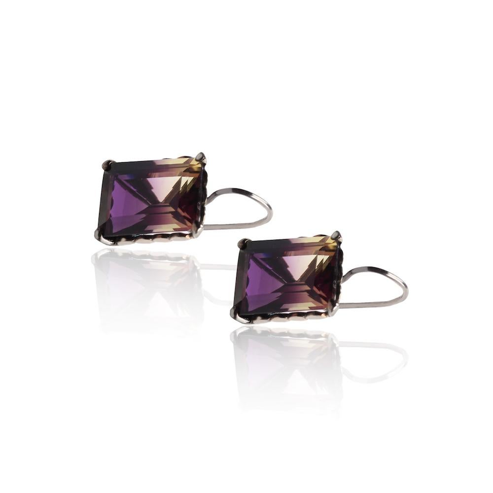 Two beautiful square Amatrinas are framed into a pair of stunning earrings. 

* Sterling Silver
* Amethyst  
* Authenticity & Guarantee Certificate
* Comes in a protective card box and felt bag