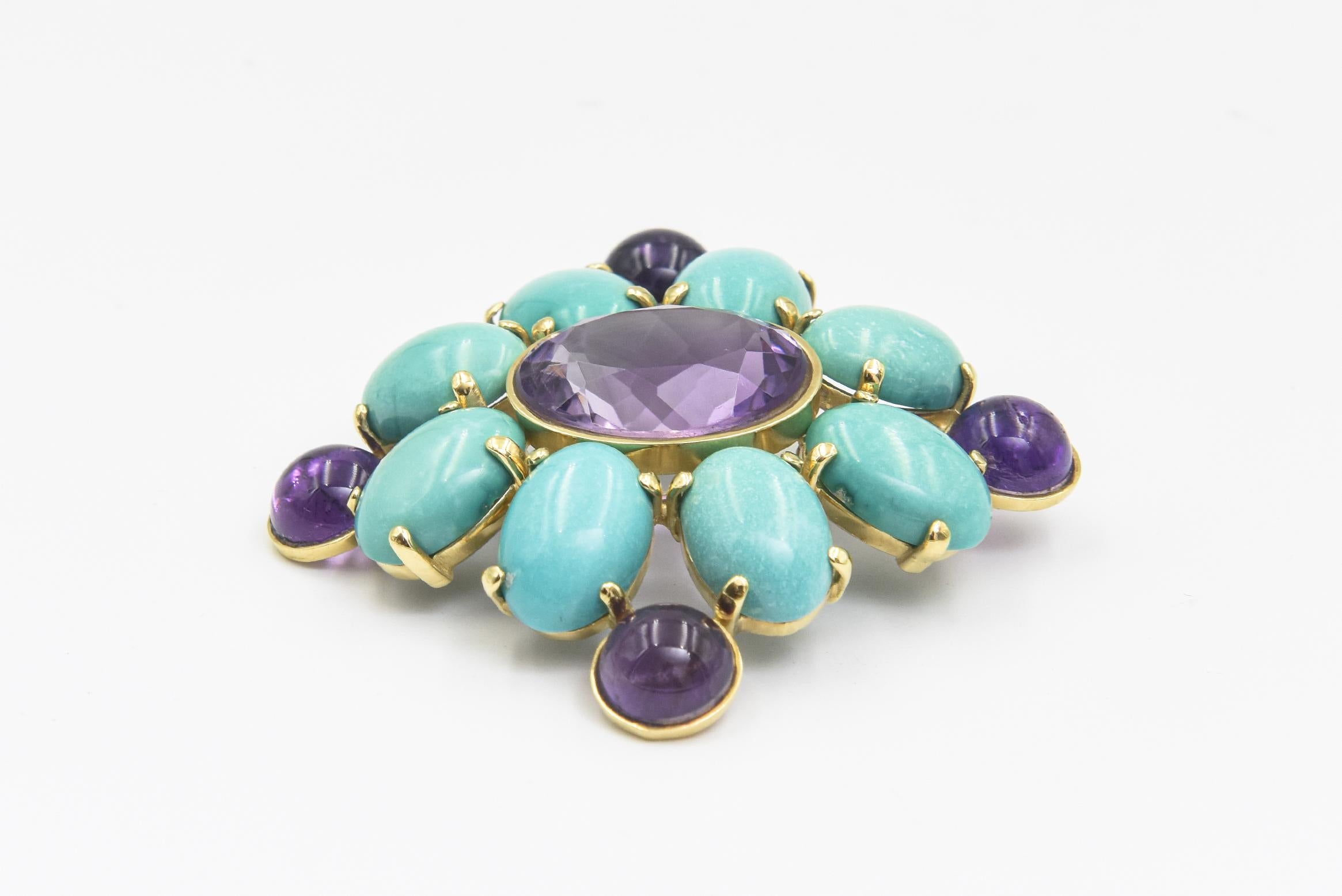 Stunning brooch in the shape of an abstract Maltese cross.  this Italian 18k yellow gold brooch featuring a centrally set facetted oval amethyst surrounded by eight oval cabochon turquoises and four round cabochon amethyst.   Stamped 750 with an
