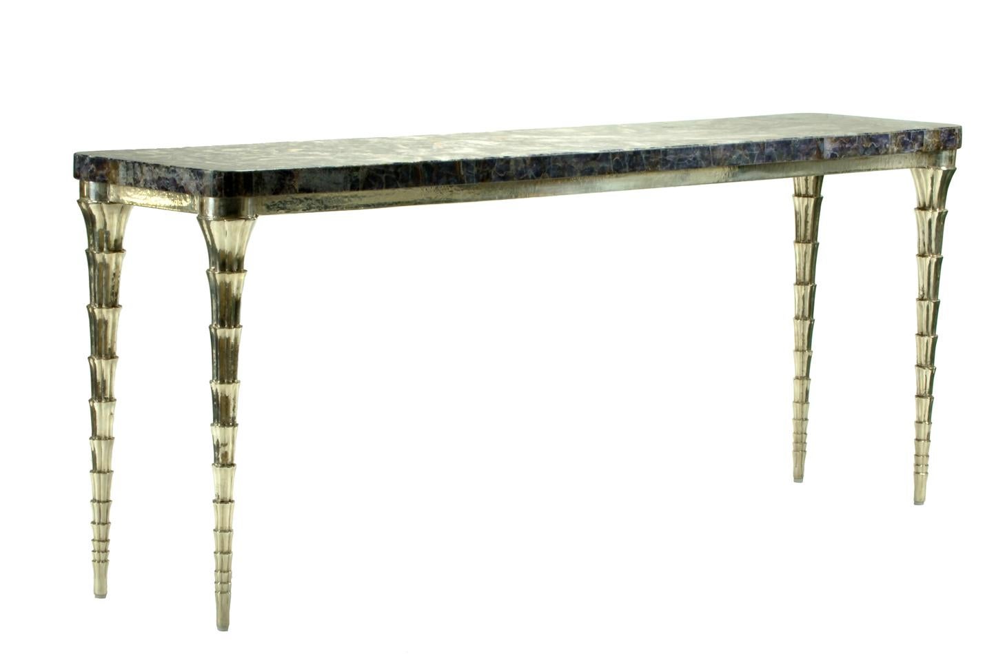 Cornet table designed by Paul Mathieu for the Stephanie Odegard Co. Ltd. Jewelry for the home, this hand carved teak console table is clad in metal and adorned with an amethyst mosaic top. The CORNET table named for the elements of the legs named