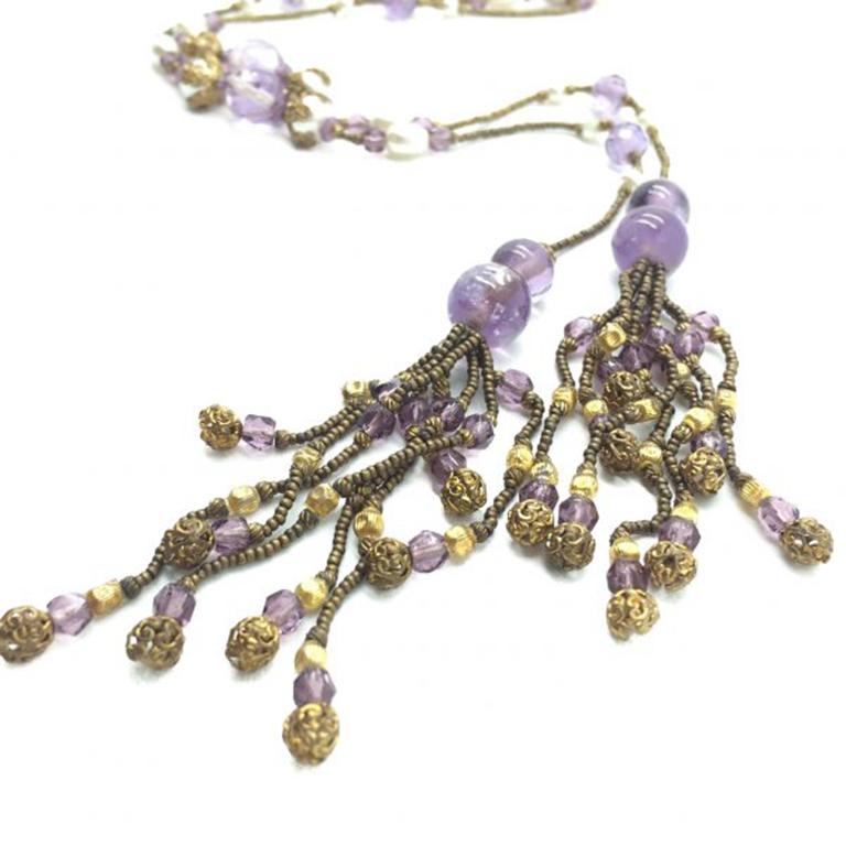 An exceptional Amethyst Sautoir Necklace dating to the early part of the 20th Century and sky high on flapper style. This incredible Amythyst Sautoir Necklace features a myriad of delightful materials and workmanship. The natural amethyst beads take