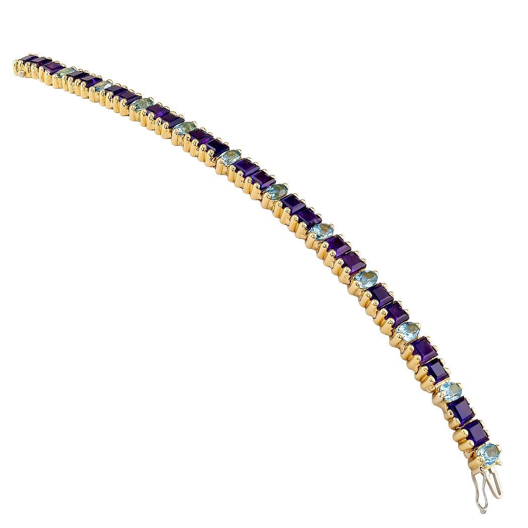 Amethyst and aquamarine gold bracelet circa 1970. The bracelet is designed as a flexible course comprising pairs of square-cut amethyst alternating with a single, oval aquamarine, the amethyst totaling approximately 11.00 carats and the aquamarine