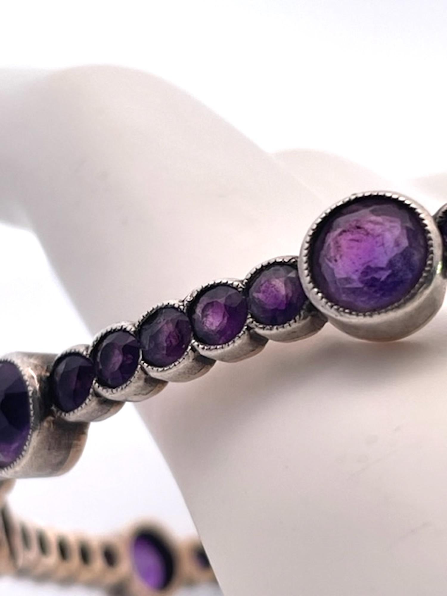 This Amethyst bangle bracelet is rare as we seldom find these bracelets surviving.  This is beautiful as it alternates between large Amethyst and smaller ones throughout this bracelet.  There are 9 large Amethysts at 0.65 points and approximate