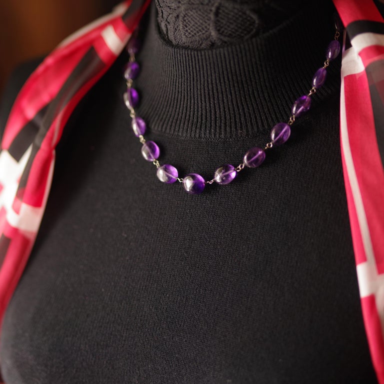 Entirely hand-fabricated during the Arts and Crafts era (circa 1910) probably in England, this beautiful and sensuous amethyst bead necklace is a jewel in every sense of the word. Each hand-polished bead is richly saturated and features natural
