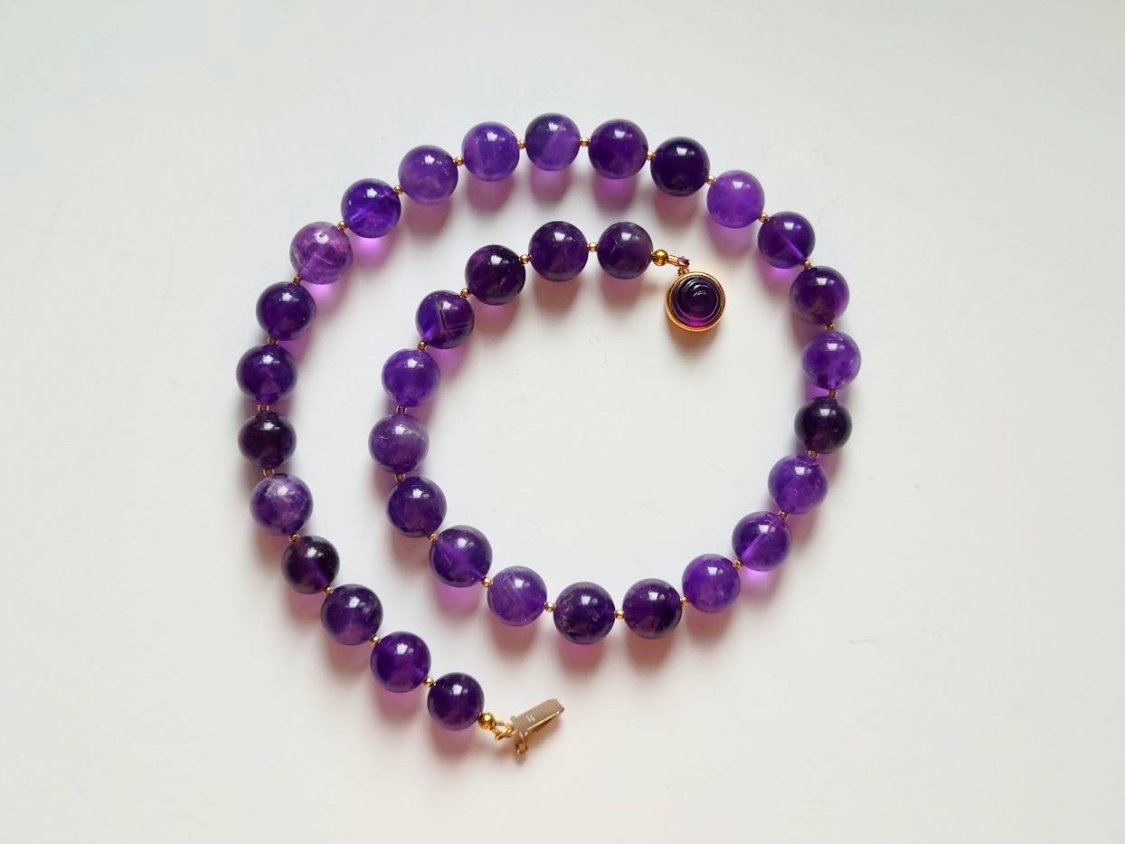 The length of the necklace is 18.5 inches (47 cm). The size of the smooth round beads is 12 mm.
The beads range from translucent to transparent in a deep purple color.
The color of the beads is authentic and natural. No thermal or other mechanical