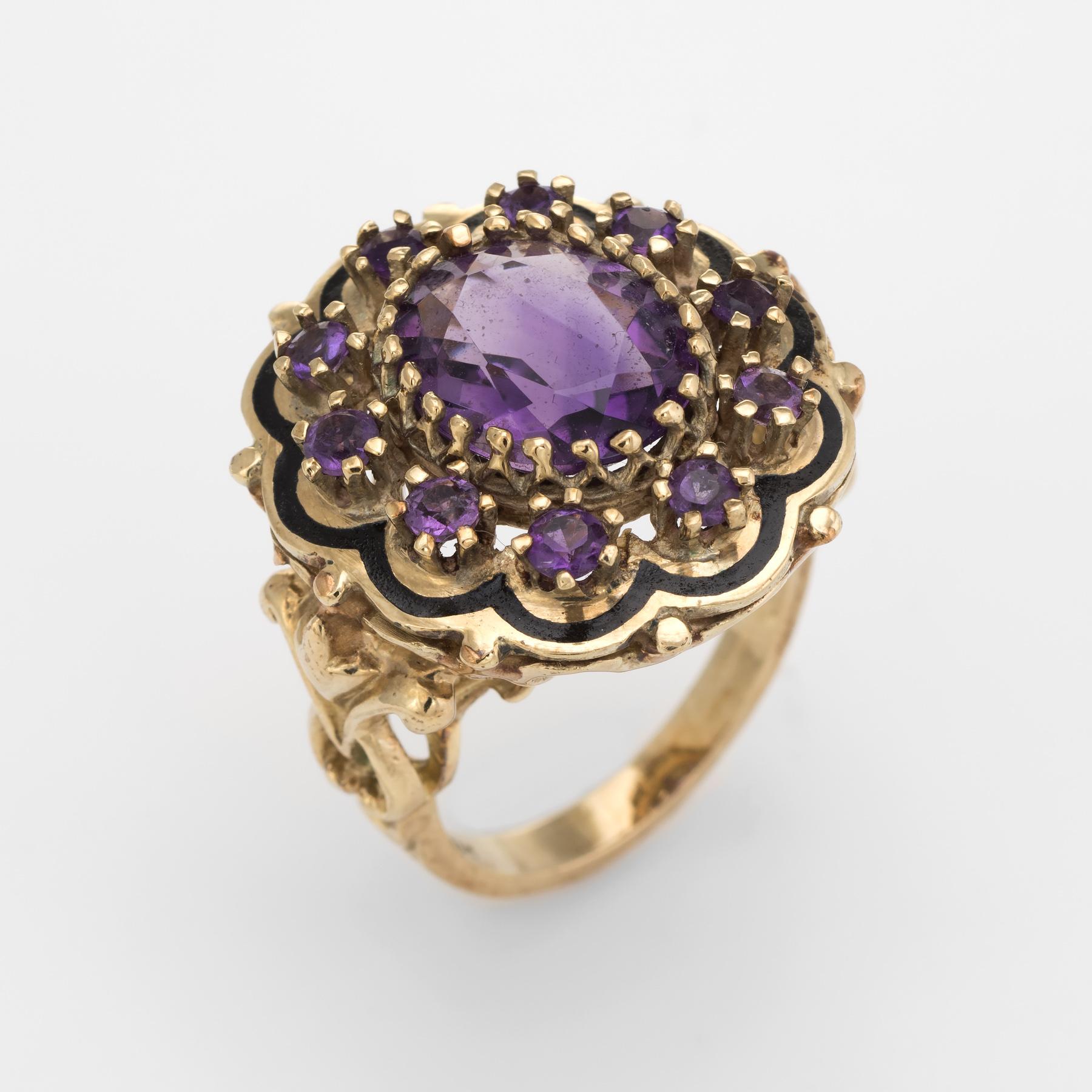 Distinct vintage amethyst cocktail ring, crafted in 14 karat yellow gold. 

Centrally mounted amethyst measures 12mm x 10mm (estimated at 4 carats), accented with 10 x 3mm amethysts. The amethysts are in excellent condition and free of cracks or