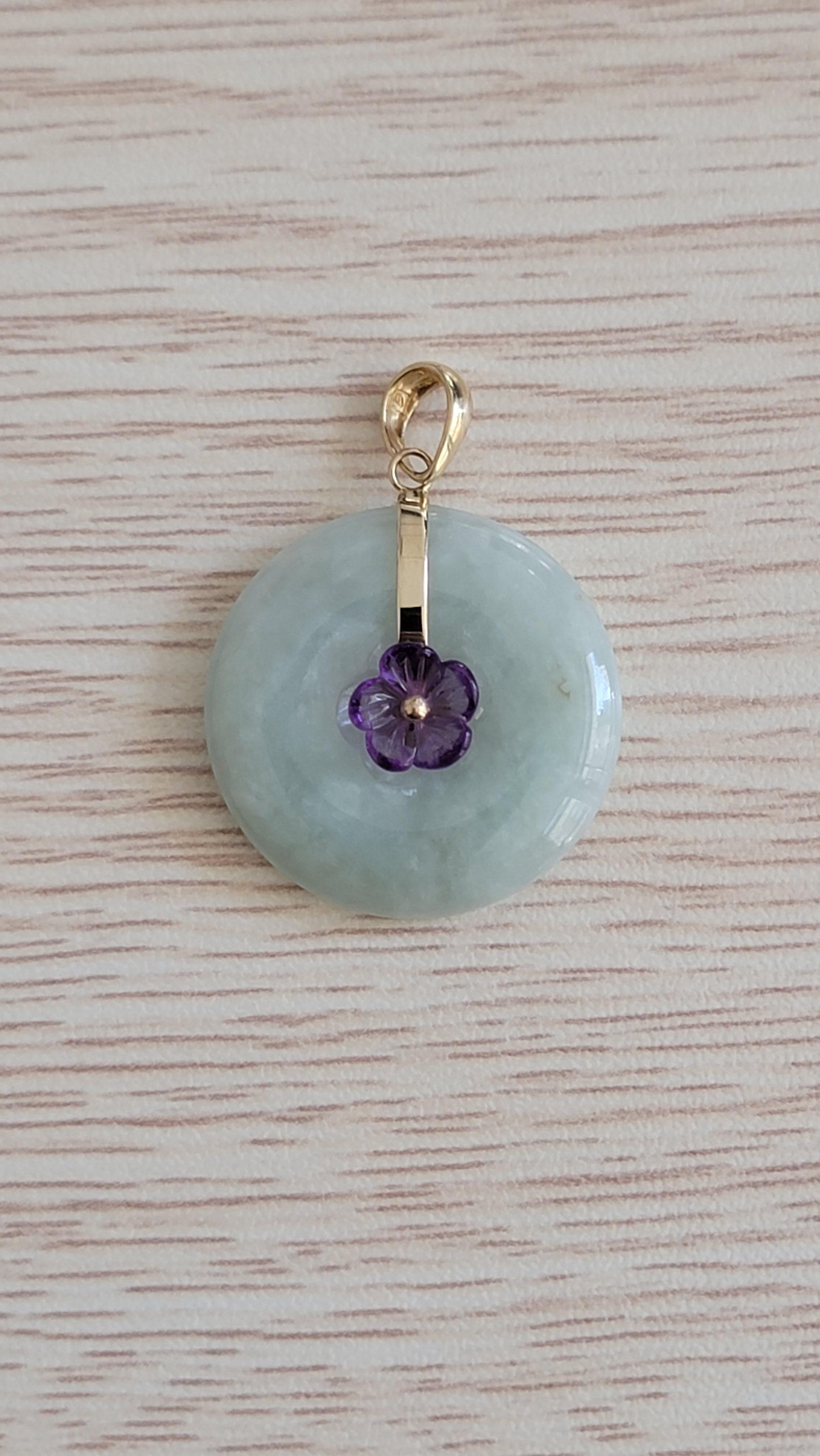 We used out classic Burmese A-Jadeite Donut shape, and put a carved Amethyst flower in the middle. The Jadeite and Amethyst interplay with their optics to bring out a bold and ravishing look. Using completely 100% untreated and natural handpicked