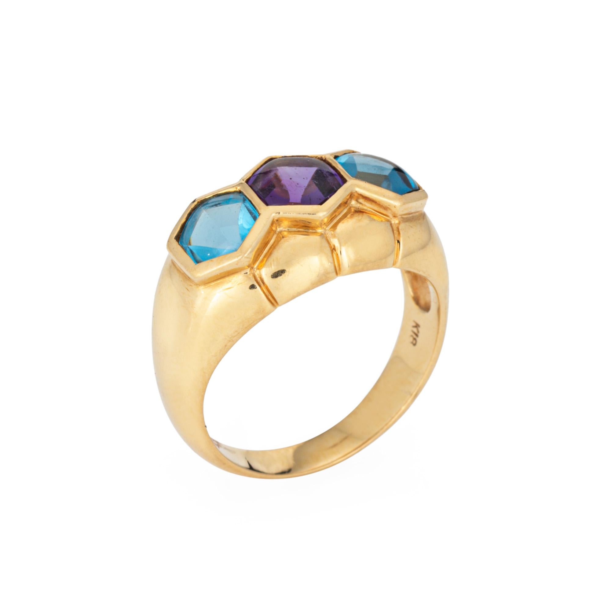 Finely detailed amethyst & blue topaz ring crafted in 18 karat yellow gold (circa 1990s). 

Amethyst measures 6mm and blue topaz measures 5mm. The stones are in very good condition and free of cracks or chips. 

Cabochon cut amethyst and blue topaz,