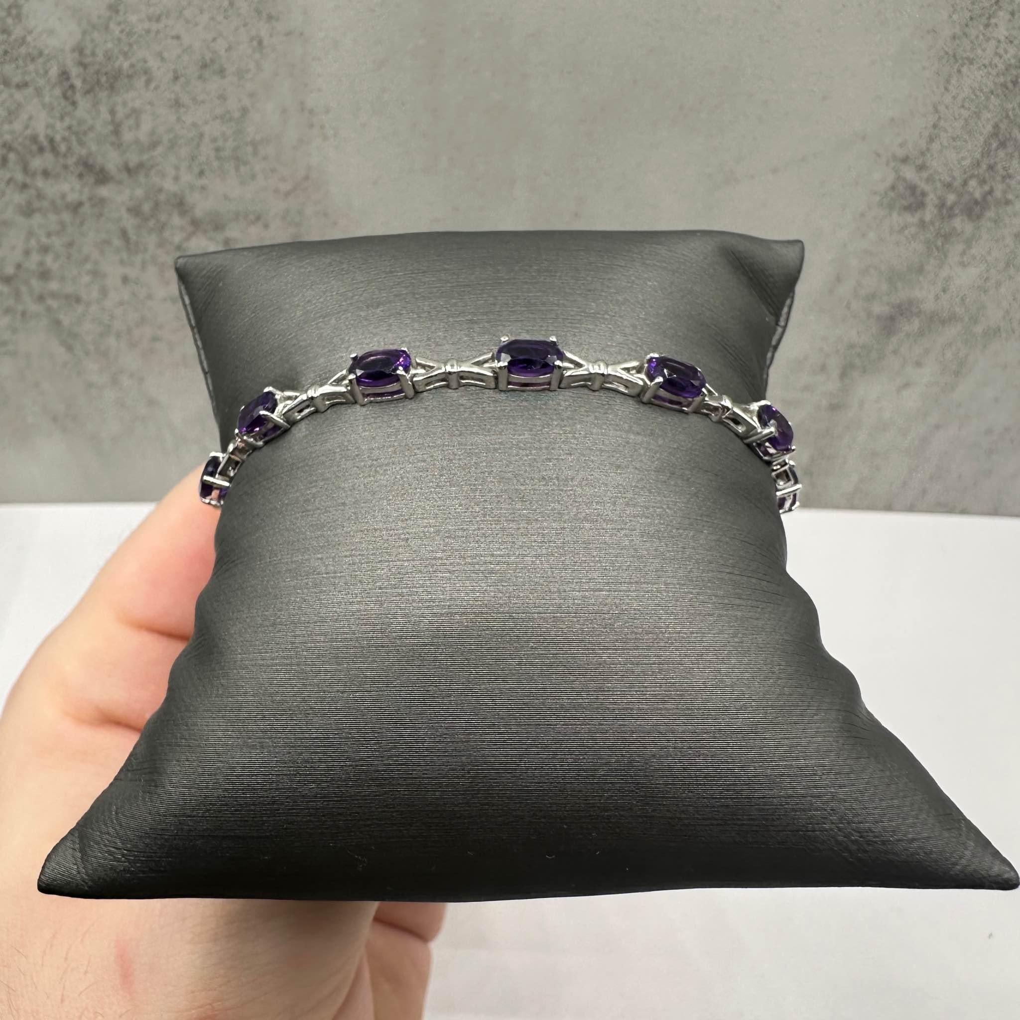 Esta impresionante pulsera de amatista en plata de ley tiene 5,5 ctw de amatistas ovaladas, que ofrecen un color intenso y elegancia. Con una longitud de 7 pulgadas, se adapta cómodamente a la mayoría de las muñecas. Con un peso de 7.6 gramos,