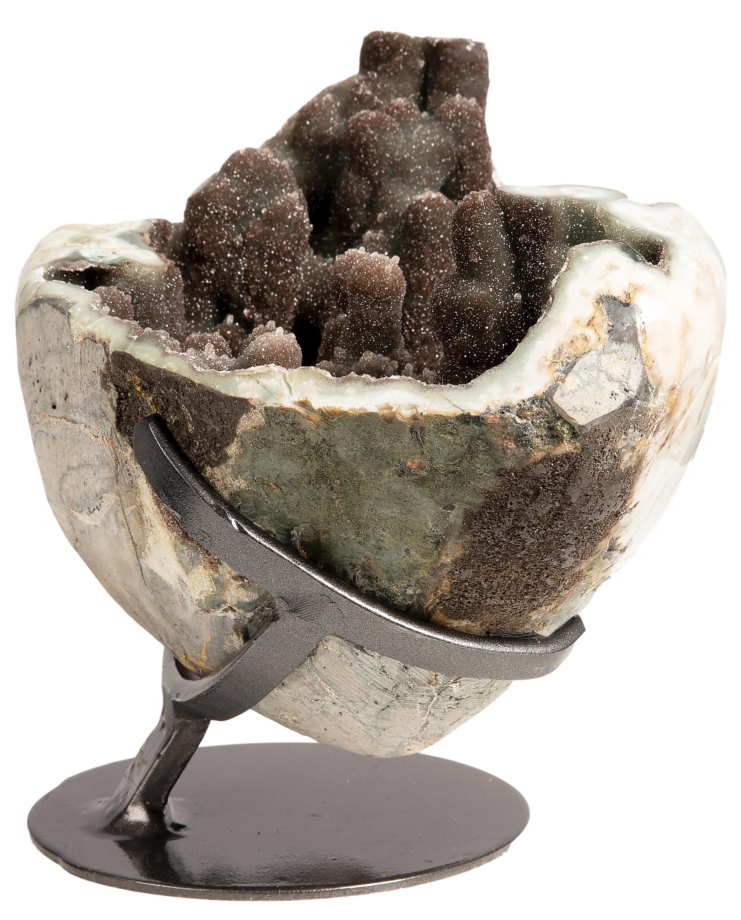 An exquisite brown druzy quartz stalactite cluster. 

The lower half of the geode is preserved, with the upper part removed to reveal the rare creation in its interior formed of many stalactites, resembling an otherworldly landscape. 



This