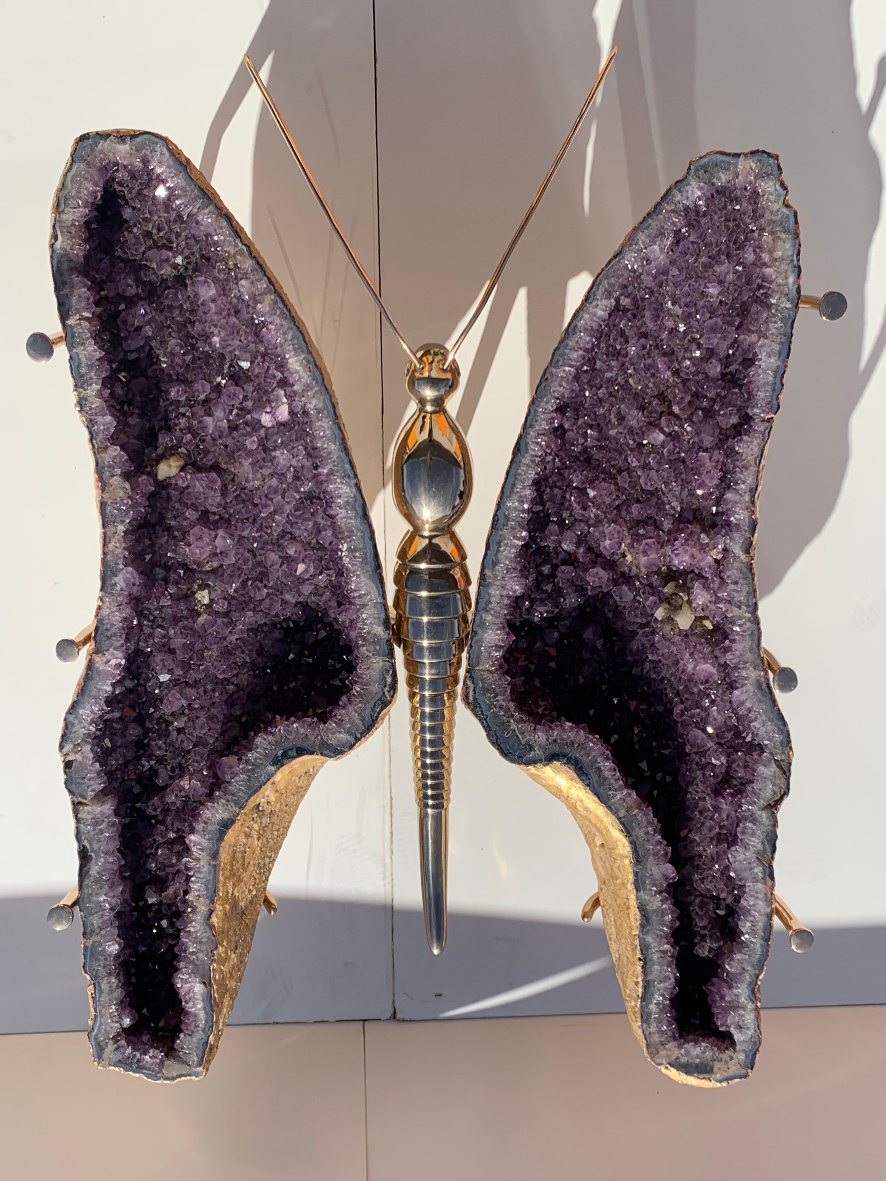 Amethyst butterfly coffee table made by Gallery Girasole. Back side of butterfly wing shaped amethyst geodes have been gilded in 22-karat gold and set in cast bronze butterfly sculpture creating a mesmerizing work of art. Each amethyst geode is