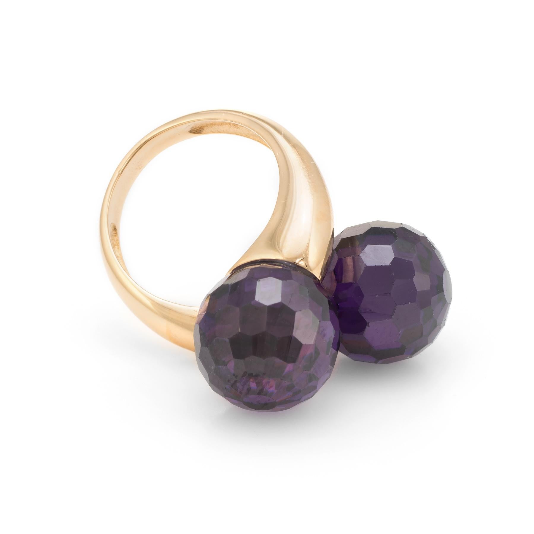 Elegant estate bypass ring, crafted in 18 karat yellow gold. 

Checkerboard faceted amethyst orbs each measure 12mm. The amethyst is in excellent condition and free of cracks or chips.   

The amethysts are set in a 'Moi et Toi' design, a French