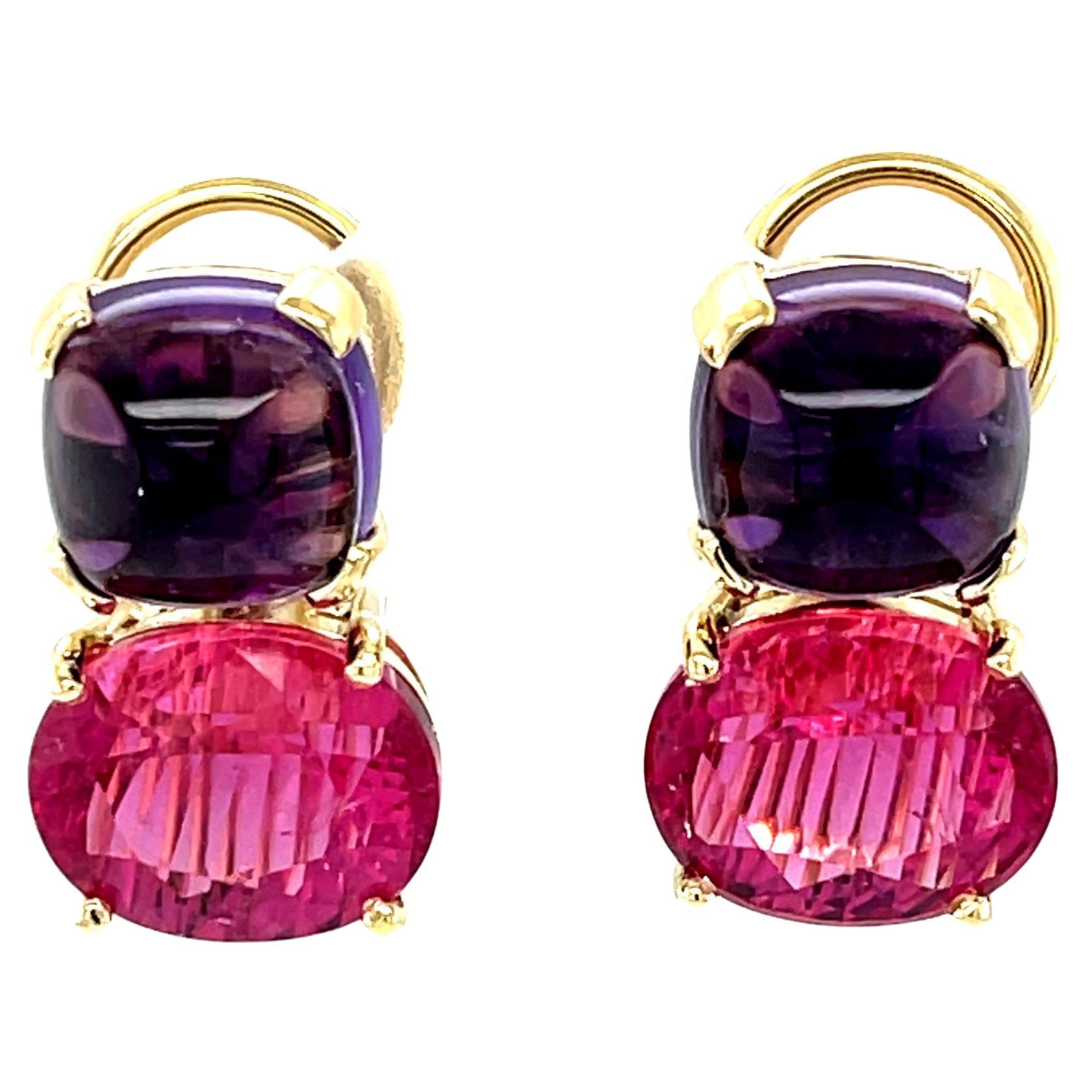These striking gemstone earrings feature beautiful royal purple amethyst cabochons and deep purplish pink rubellite tourmaline ovals set in 18k yellow gold. The rubellite tourmalines have an unusual 
