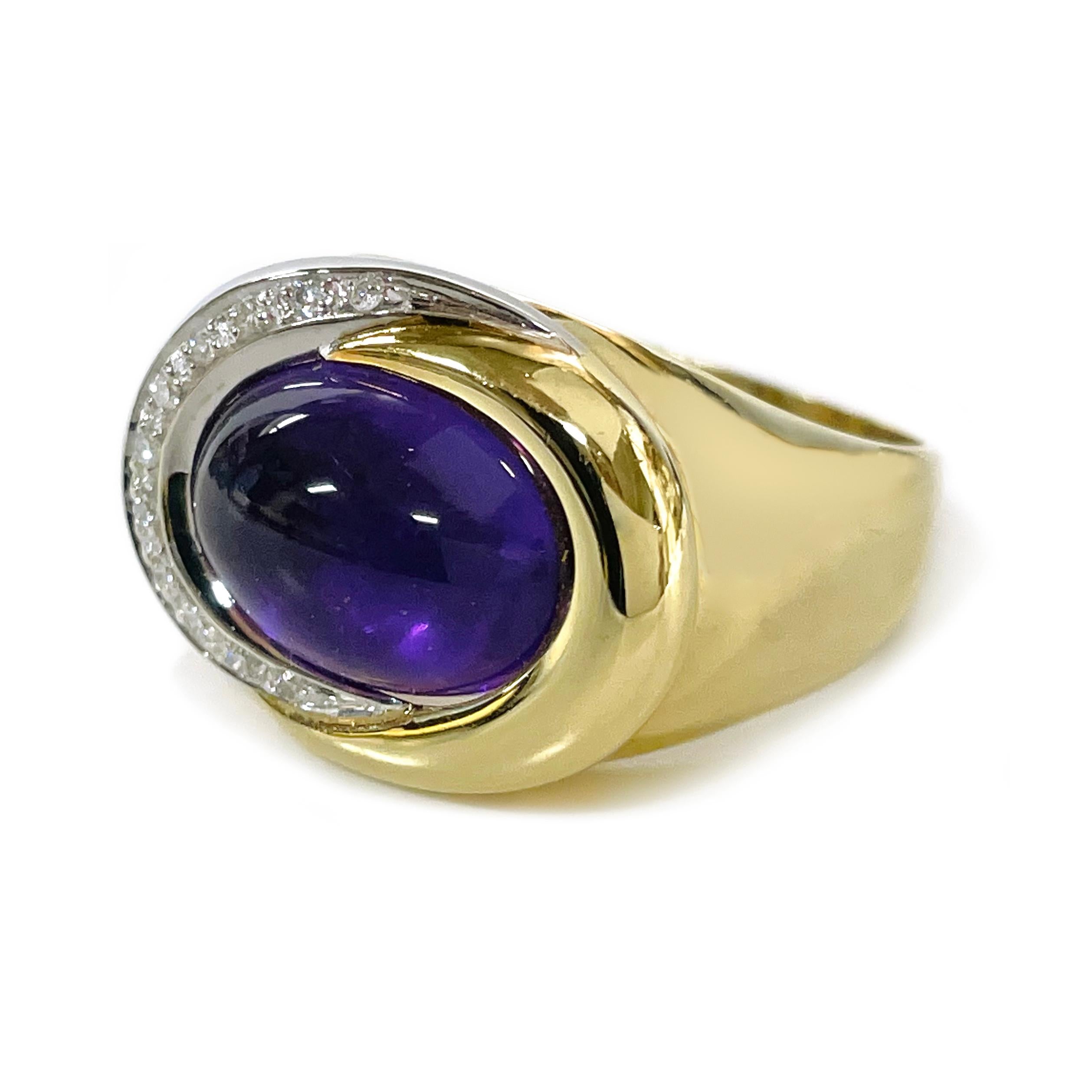 18 Karat Yellow and White Amethyst Cabochon Diamond Ring. The ring features an oval bezel-set  13.1 x 10.0mm Amethyst cabochon with a carat weight of 6.15ct. and two swooshes of gold that surround the gemstone. One of the swooshes has 12 melee