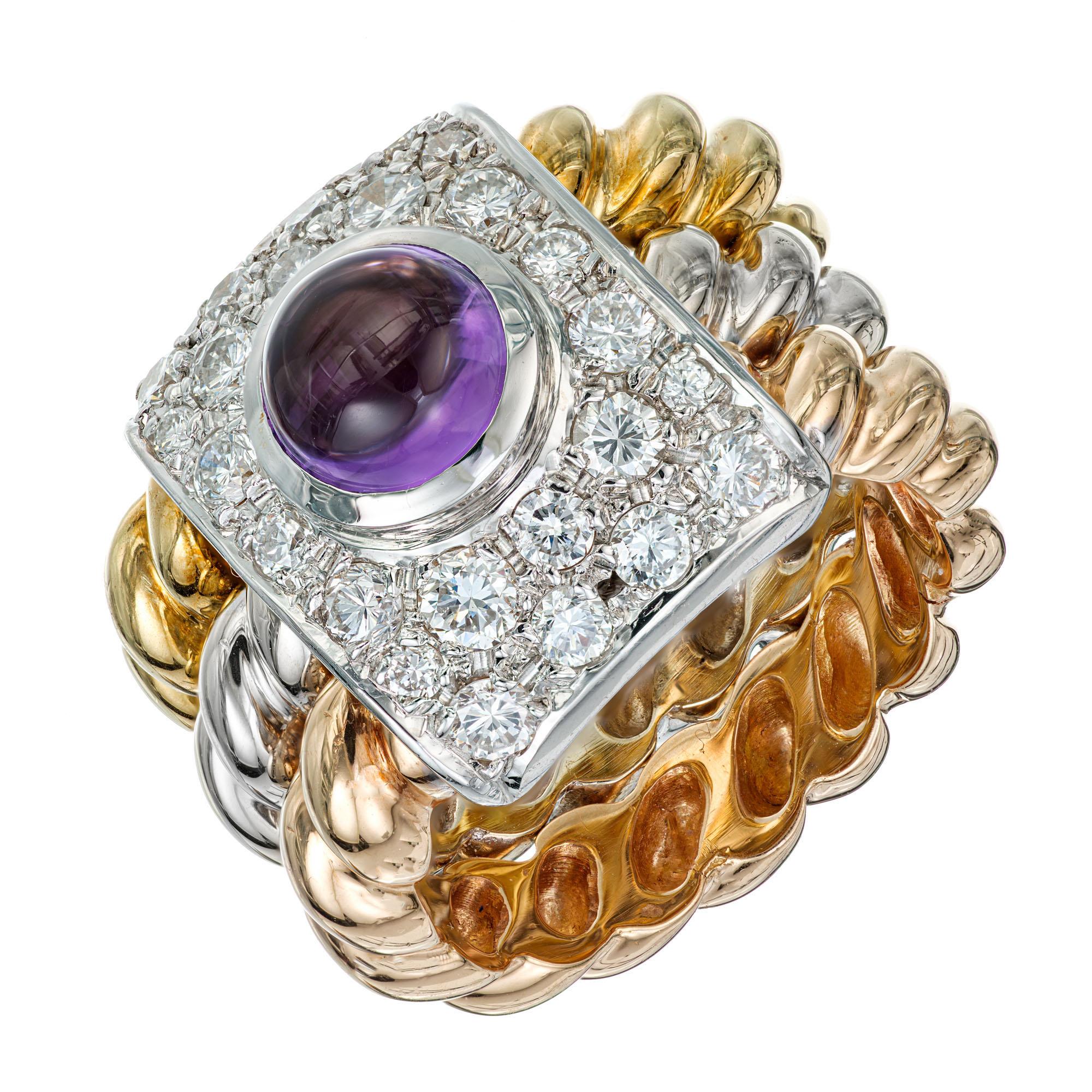 Amethyst and diamond tri-color ring. 1.00ct center cabochon amethyst with a square halo of 24 round diamonds. 18k Rose, white and yellow gold twist bands with a white gold diamond plate.

1 6mm genuine Amethyst cabochon, approx. total weight