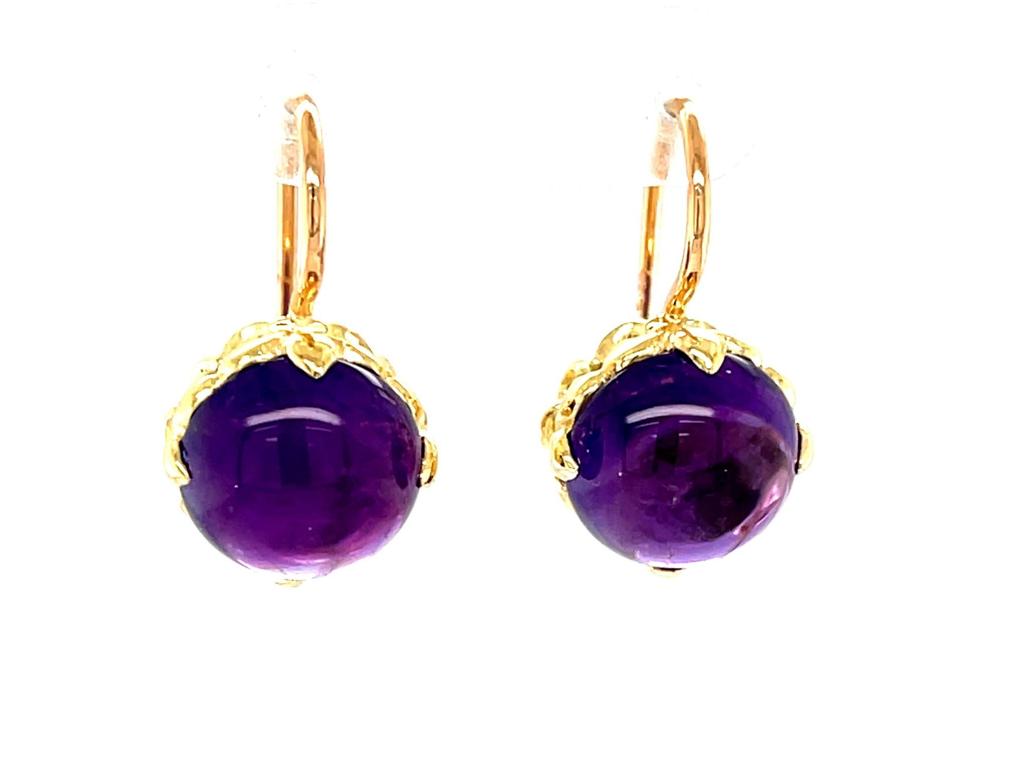 These gorgeous amethyst drop earrings feature a beautifully matched pair of round, royal purple amethyst cabochons set in 18k yellow and rose gold! The amethyst are set in 18k yellow gold, hand-fabricated fleur de lis baskets that make these