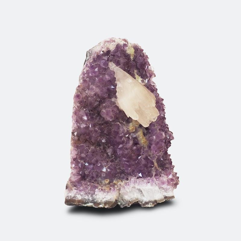 An amethyst crystal with central calcite piece.
  