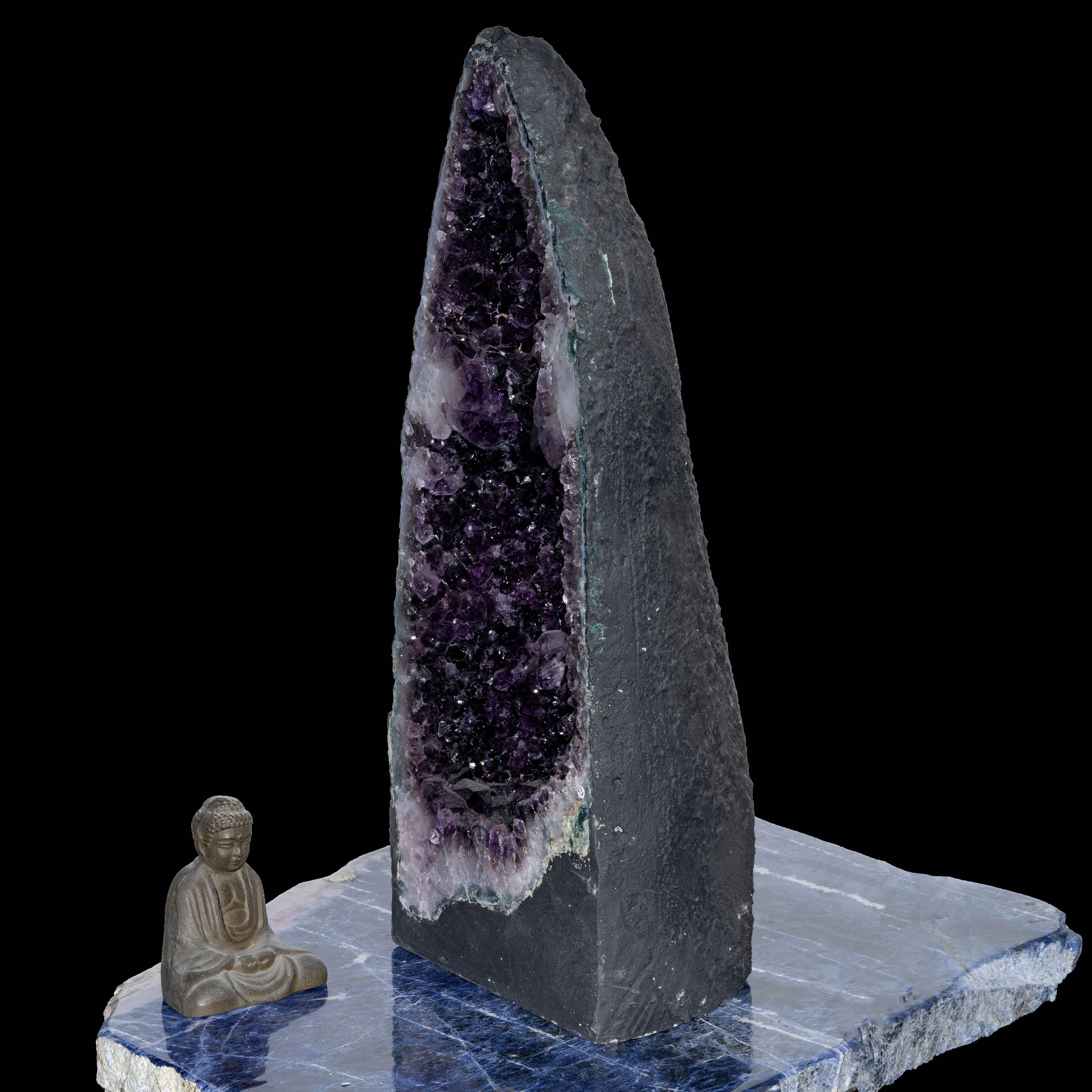 This over two foot tall stabilized amethyst cathedral from Brazil glistens from within with a lustrous coating of naturally terminated, fully formed, purple-drenched amethyst crystals. With a pale banded agate rim that pops against the amethyst,