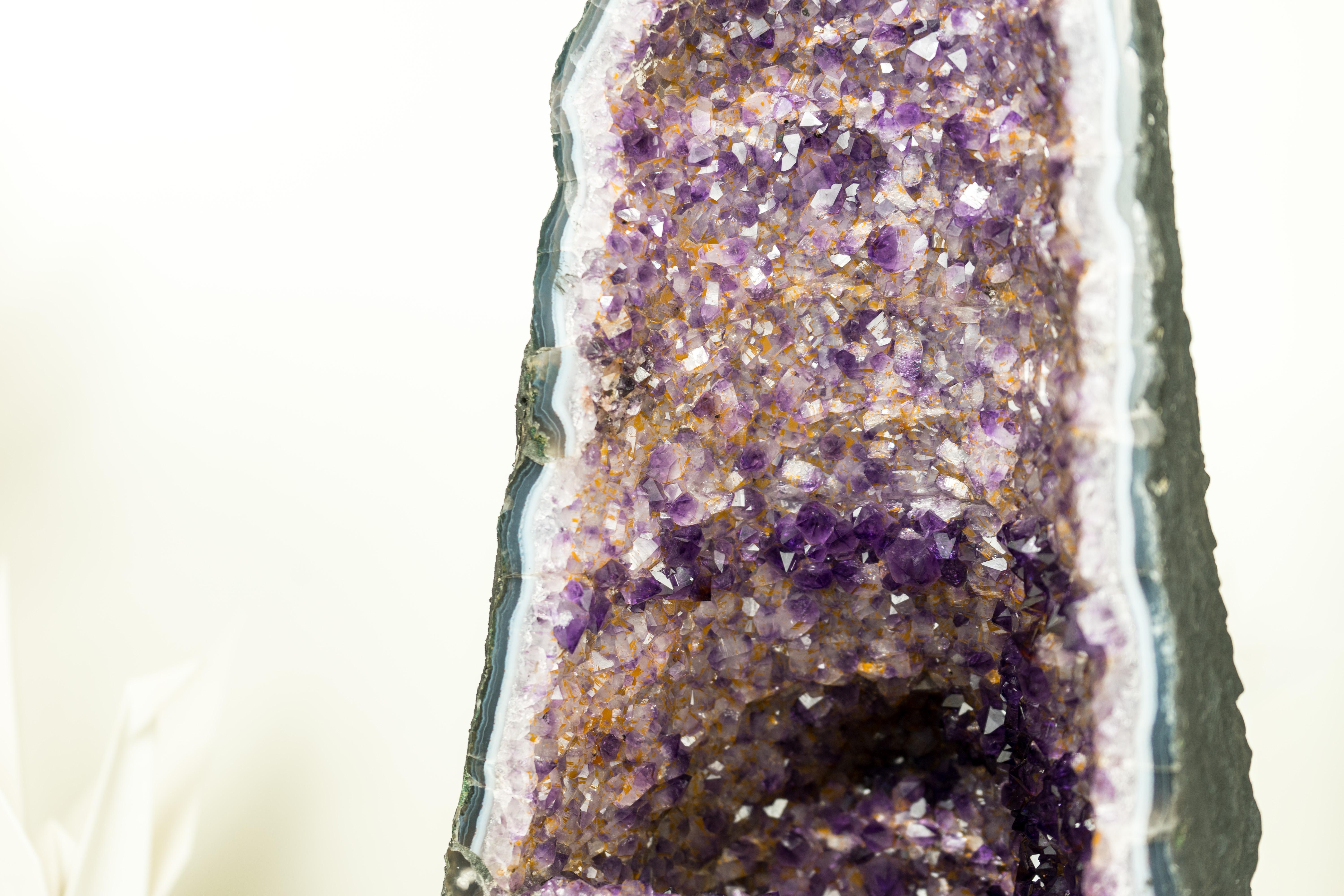 An extraordinary Amethyst Geode that showcases a superb formation with two distinct colors, this geode showcases a blend of deep purple Amethyst lines that intricately interlace with lines of lavender Amethyst, creating a unique and rarely seen mix