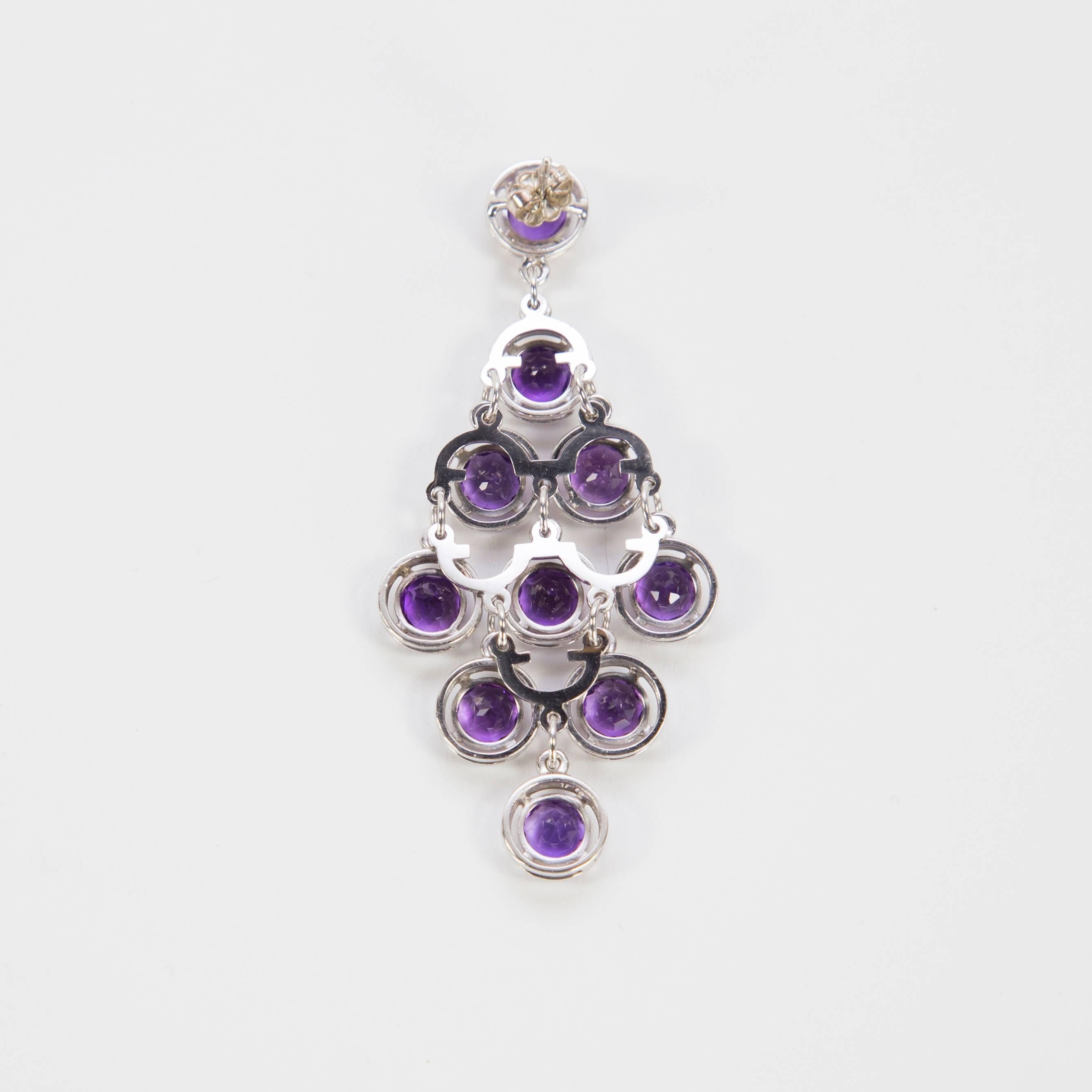 Sensational Chandelier Dangle Earrings set with twenty round faceted Amethyst stones mounted in 14k white gold hand crafted 4-claw setting with post and butterfly closure; measuring approx. 2.5” long. A perfect complement to every wardrobe…