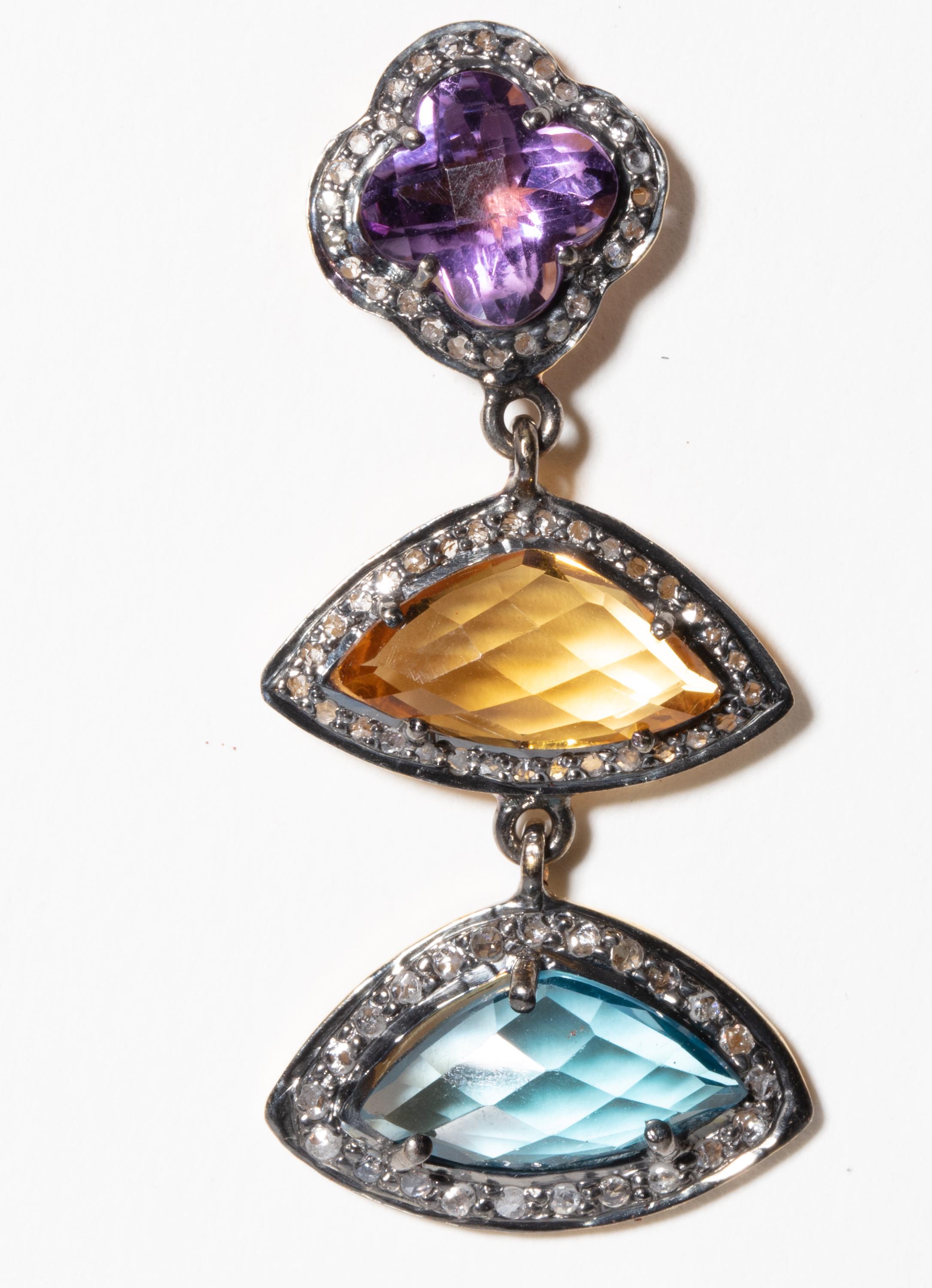 A pair of multi-colored drop earrings consisting of faceted amethyst, citrine and blue topaz all surrounded by pave`-set diamonds in an oxidized sterling silver with 18K gold post for pierced ears.  Carat weight of diamonds is .75; the weight of the