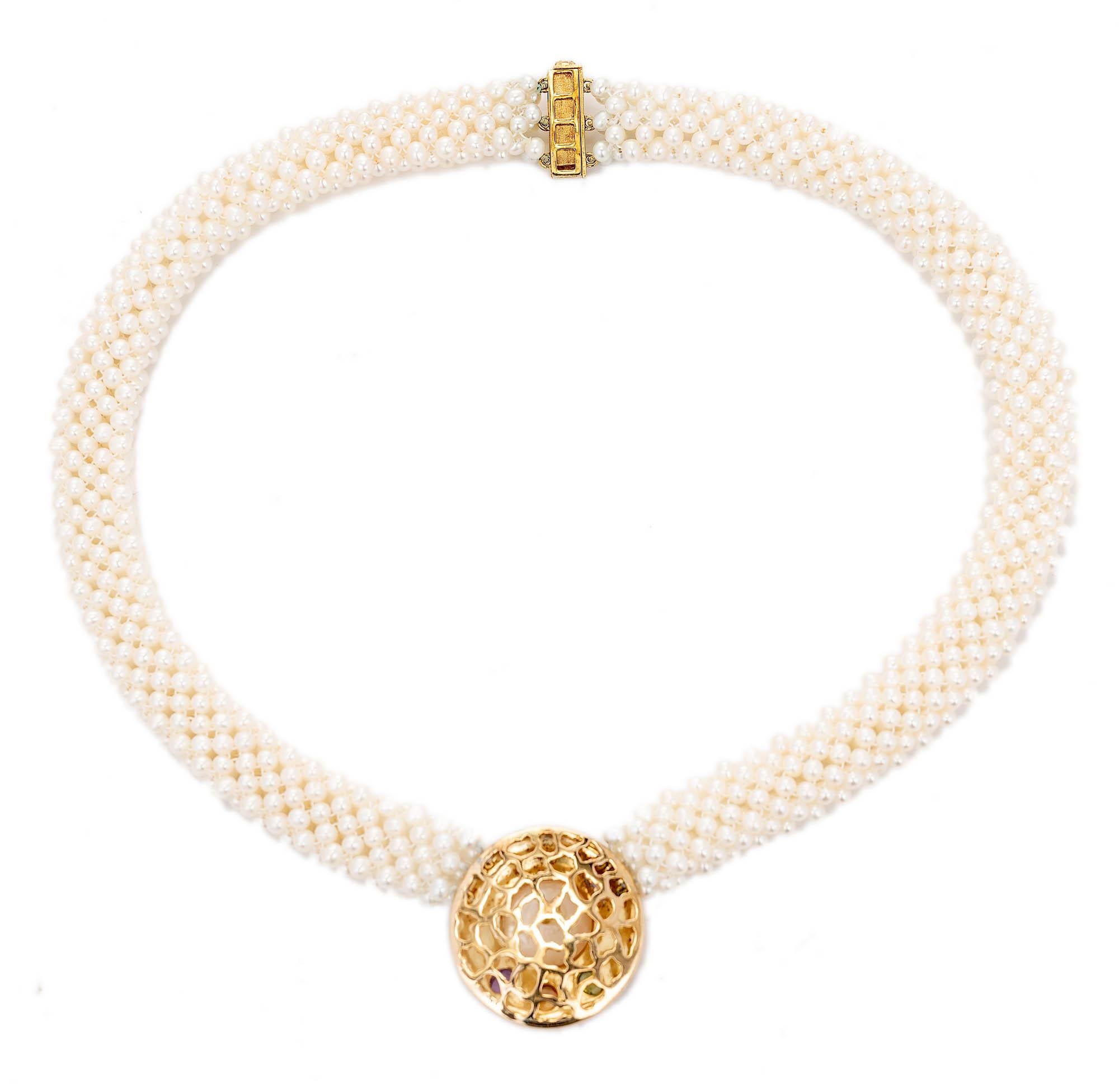 Twelve Strand three-dimensional pearl necklace with an 18k centerpiece made of textured yellow gold with a 12mm mabe pearl bezel set in the center and three  gem stones set underneath the pearl.

1 mabe pearl 12mm
3 oval cabochon Amethyst, citrine