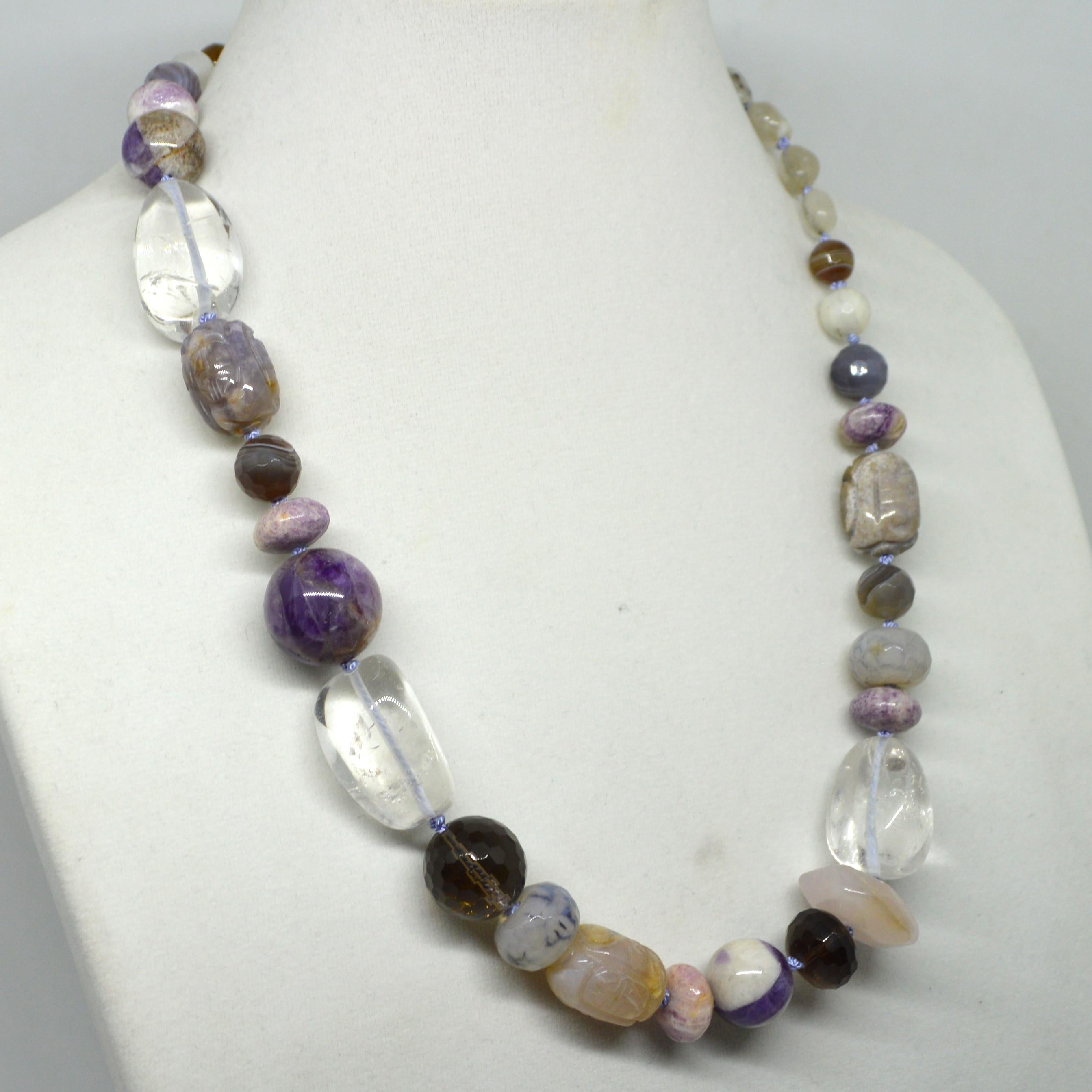 Mix of Carved Faceted and polished stones makes this beautiful necklace.
Stones included are Moonstone, Botswania Agate, Banded amethyst, Smokey Quartz, Rose Quartz, Clear Quartz and Carved Agate with a Sterling Silver Clasp.
 Finished Necklace