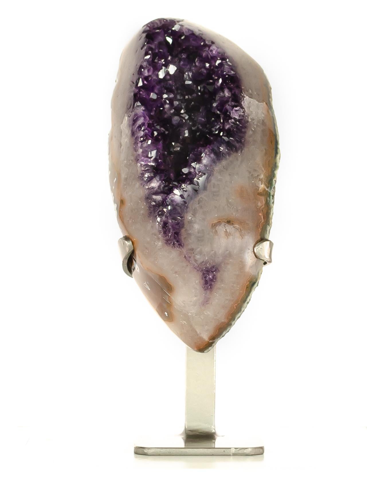 A pleasing crescentic section of quartz with agate areas, surrounding a beautiful vibrant streak of deep purple amethyst.

This crescentic medium sized section has a wonderful thick white quartz border
with an intense purple amethyst core.