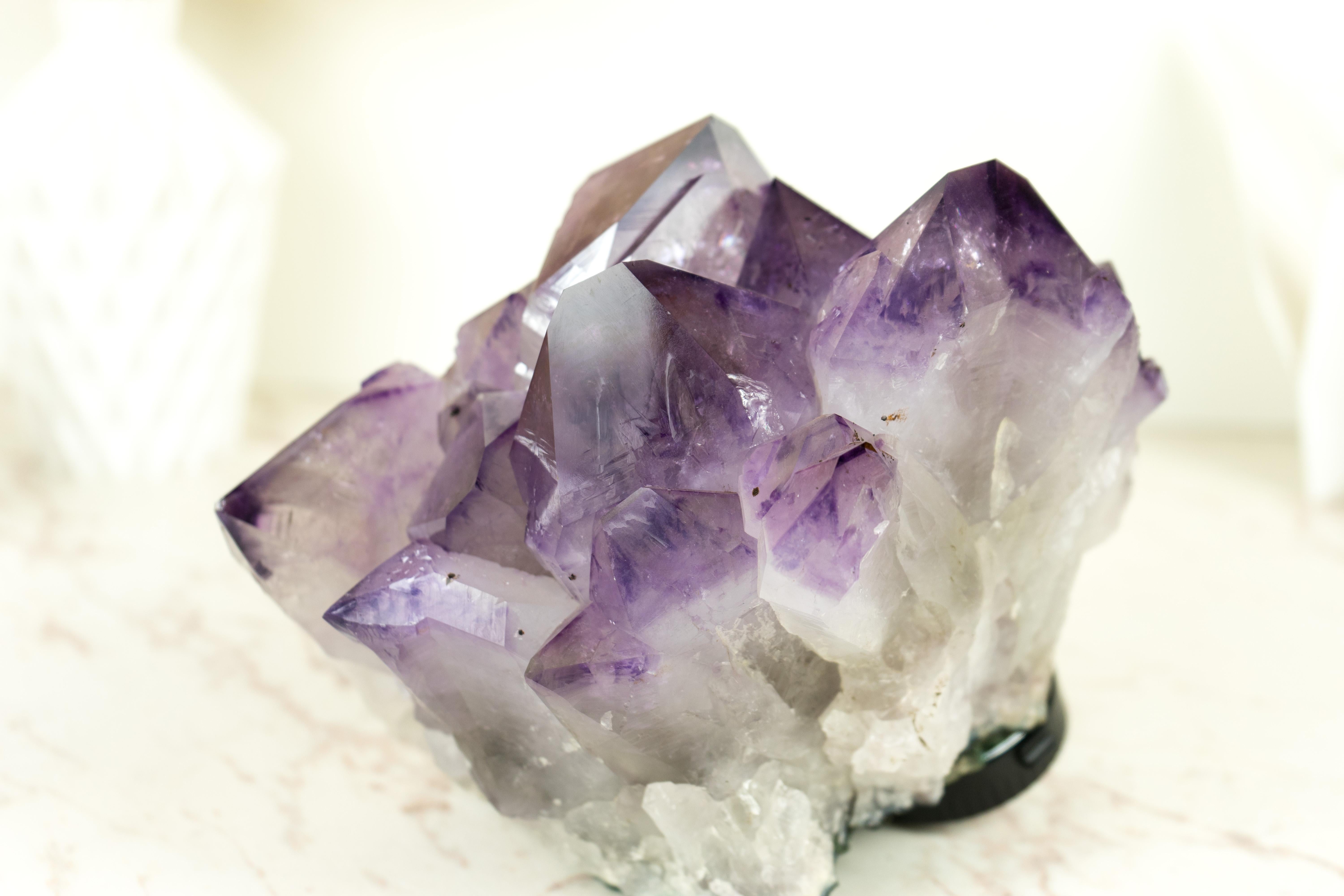 With world-class characteristics, this extraordinary Amethyst Cluster from Brazil brings Phantom Crystal Amethyst lines, X-Large sized points, as well as the perfectly intact quality of the druzy, making it a standout centerpiece for any collection