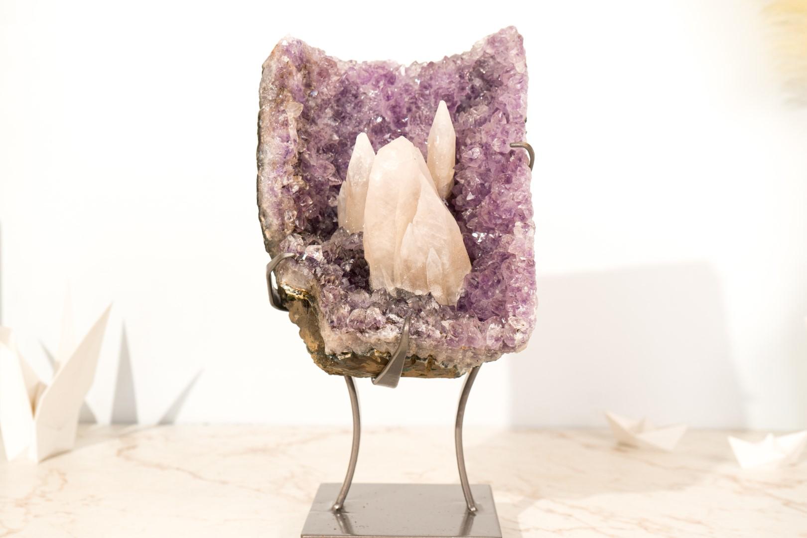 A small but gorgeous amethyst cluster, this deep purple specimen showcases a rarely seen formation of UV-reactive calcite arranged as a geological landscape, with tall, intact calcite growing among lavender amethyst. When exposed to UV light, this